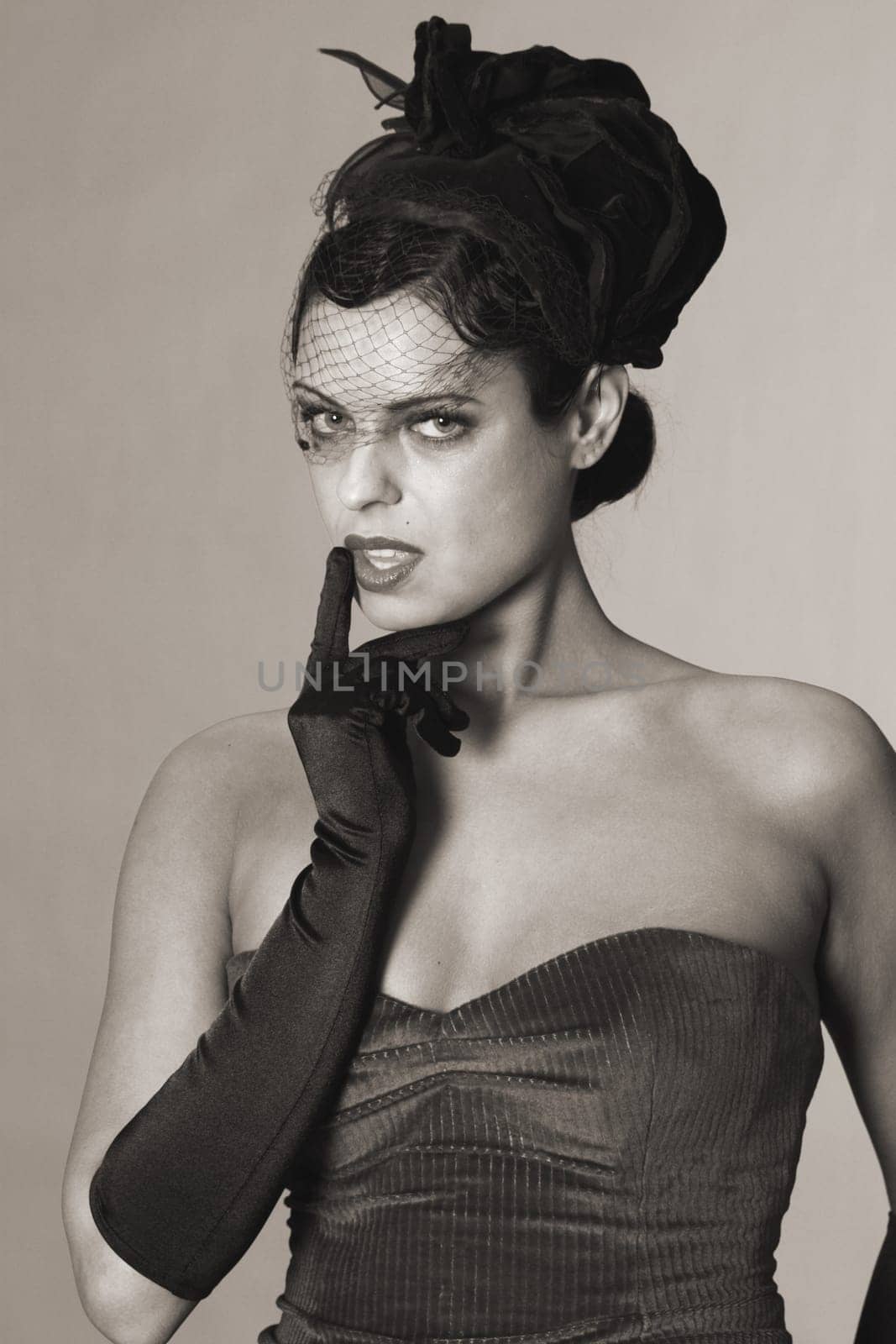 Woman in styling of the 20s,erotic with finger on mouth