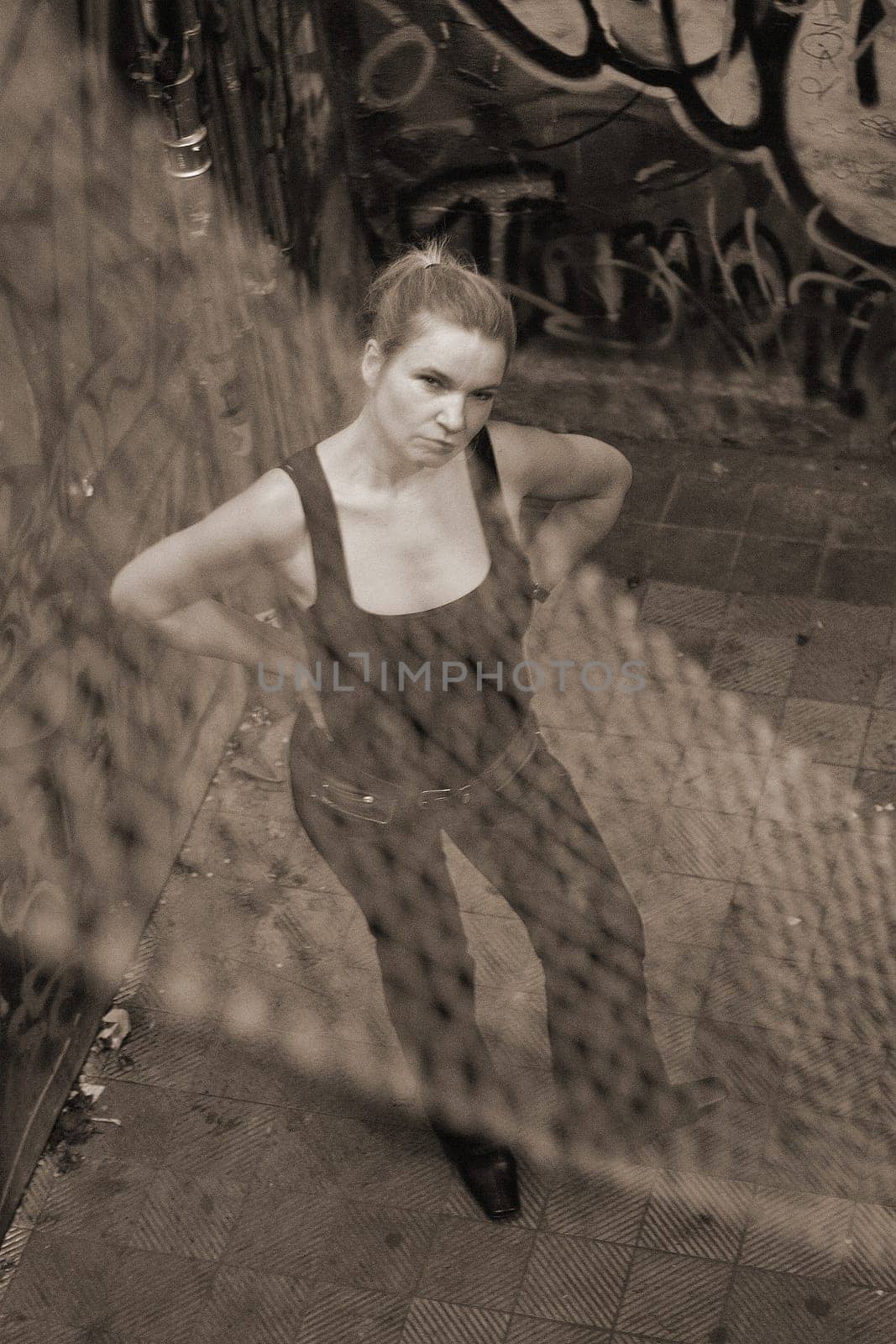 Woman standing in a building full of graffiti