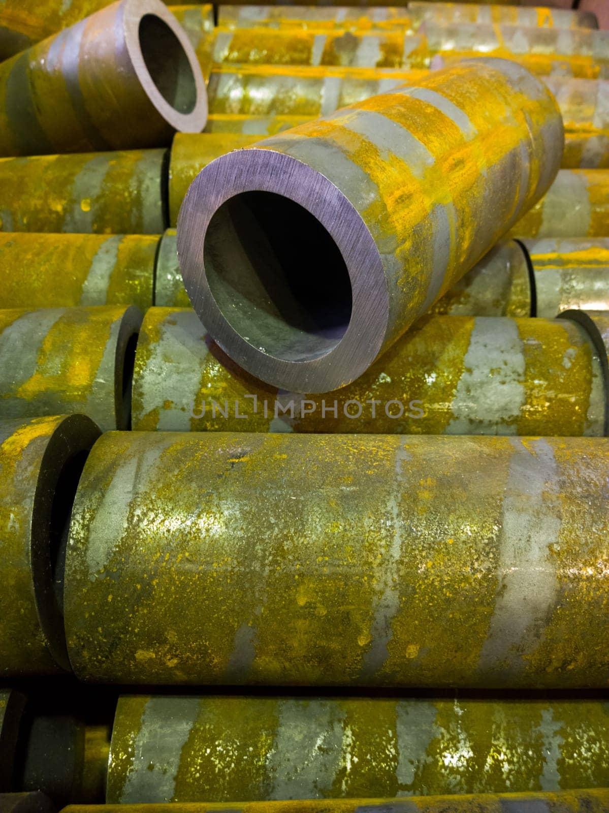 rusted thick steel pipe chunks after sawing waiting for machining operations.