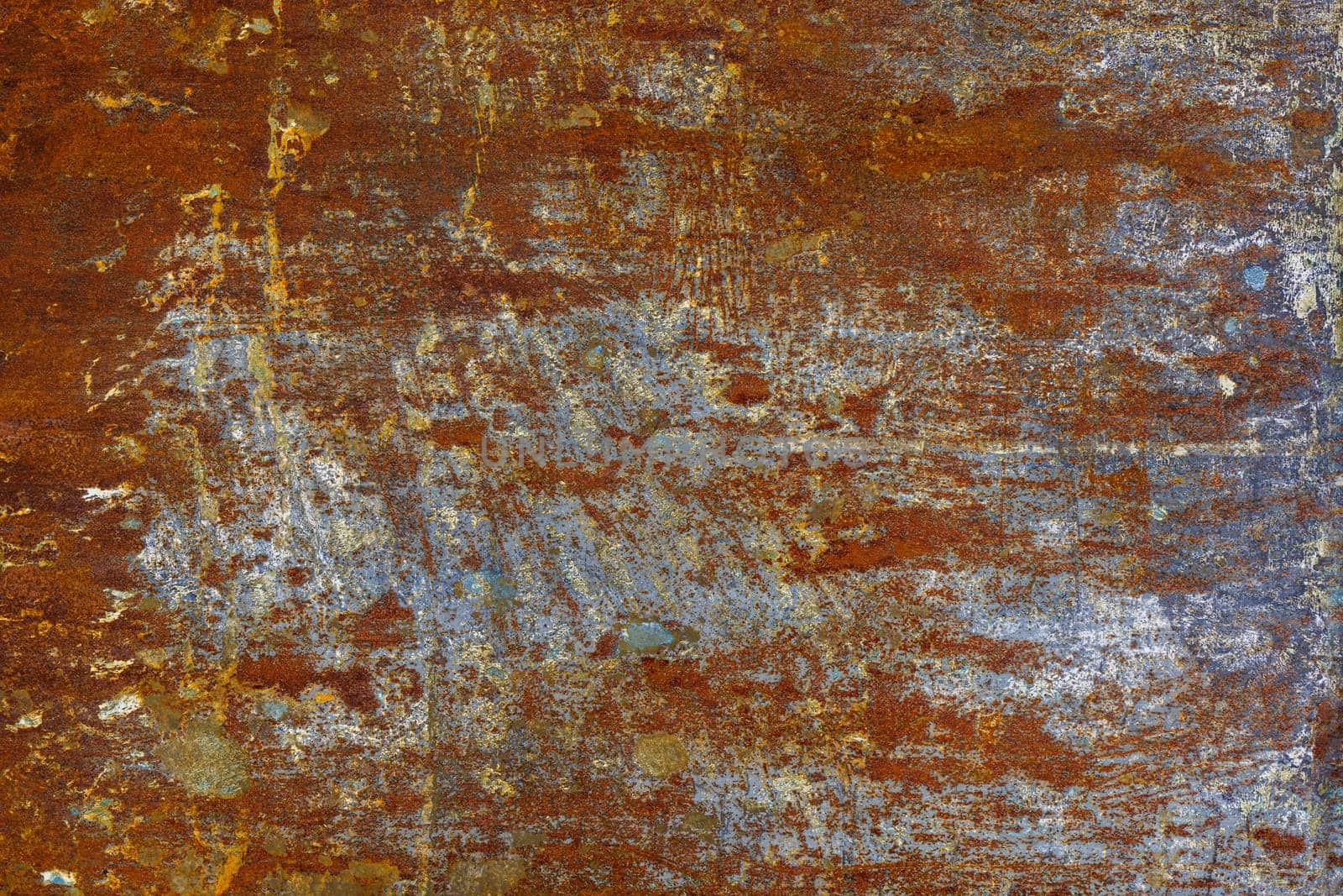 flat artistically rusted steel surface with leftovers of gray paing - full-frame background and texture.