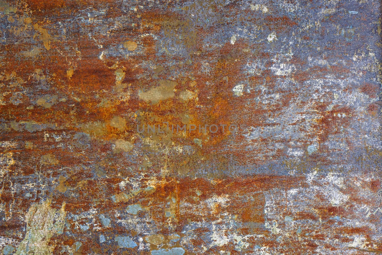 flat artistically rusted steel surface with leftovers of gray paing - full-frame background and texture.