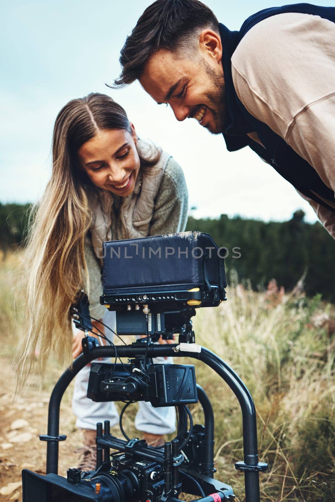 Camping, camera and couple in nature with photography equipment for shooting on outdoor adventure. Forest, fun and photographer people prepare device for recording podcast or blog content for travel.