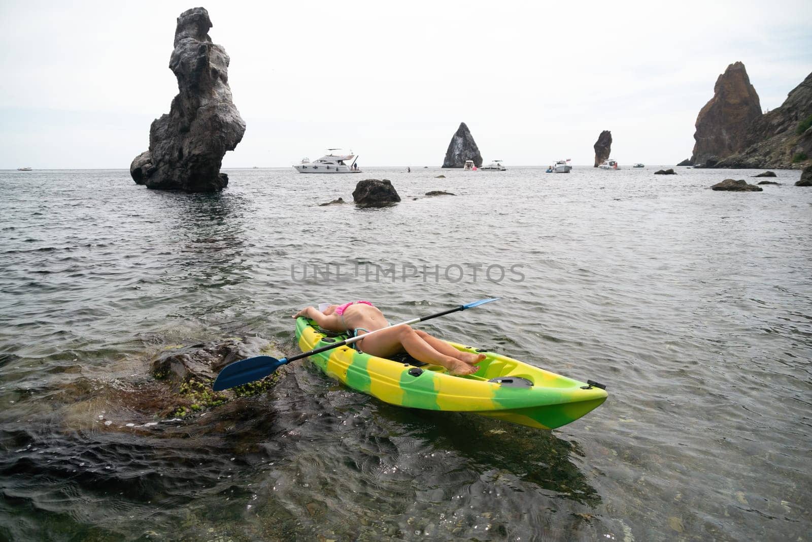 Kayaking. Travel adventure kayak on the tropical sea on a sunny day. Woman rowing a canoe.