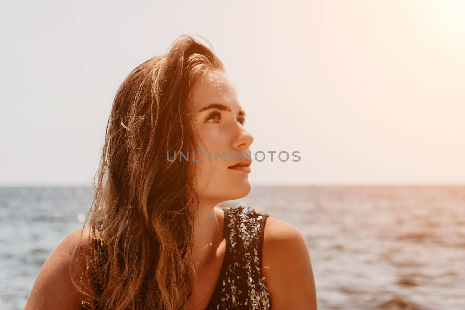 Woman summer travel sea. Happy tourist enjoy taking picture outdoors for memories. Woman traveler posing on the beach at sea surrounded by volcanic mountains, sharing travel adventure journey by panophotograph