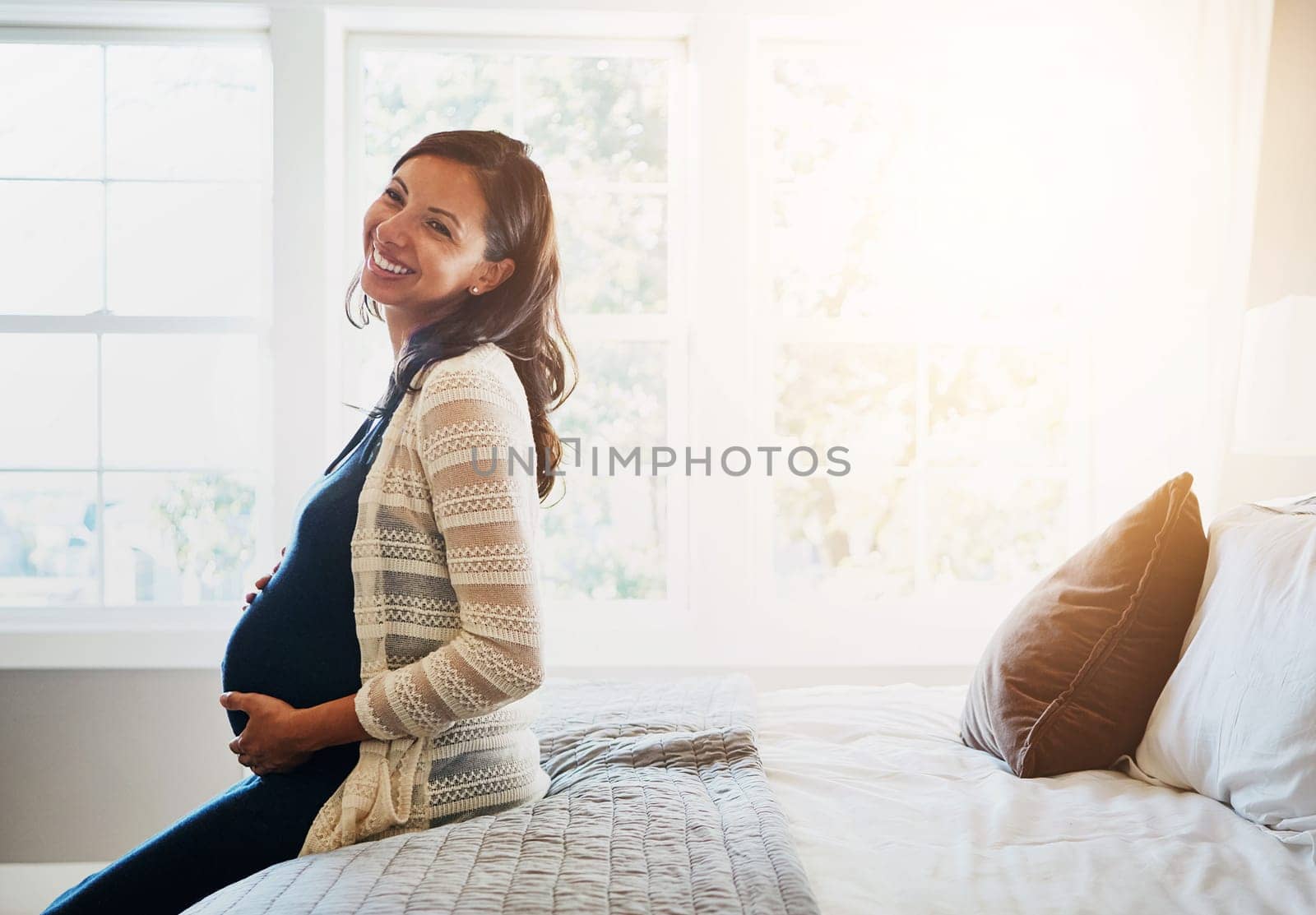 Bedroom, happiness and home portrait of pregnant woman holding stomach, abdomen or belly with love, care and baby support. Pregnancy, bed and person smile, maternity and hope for future life growth by YuriArcurs
