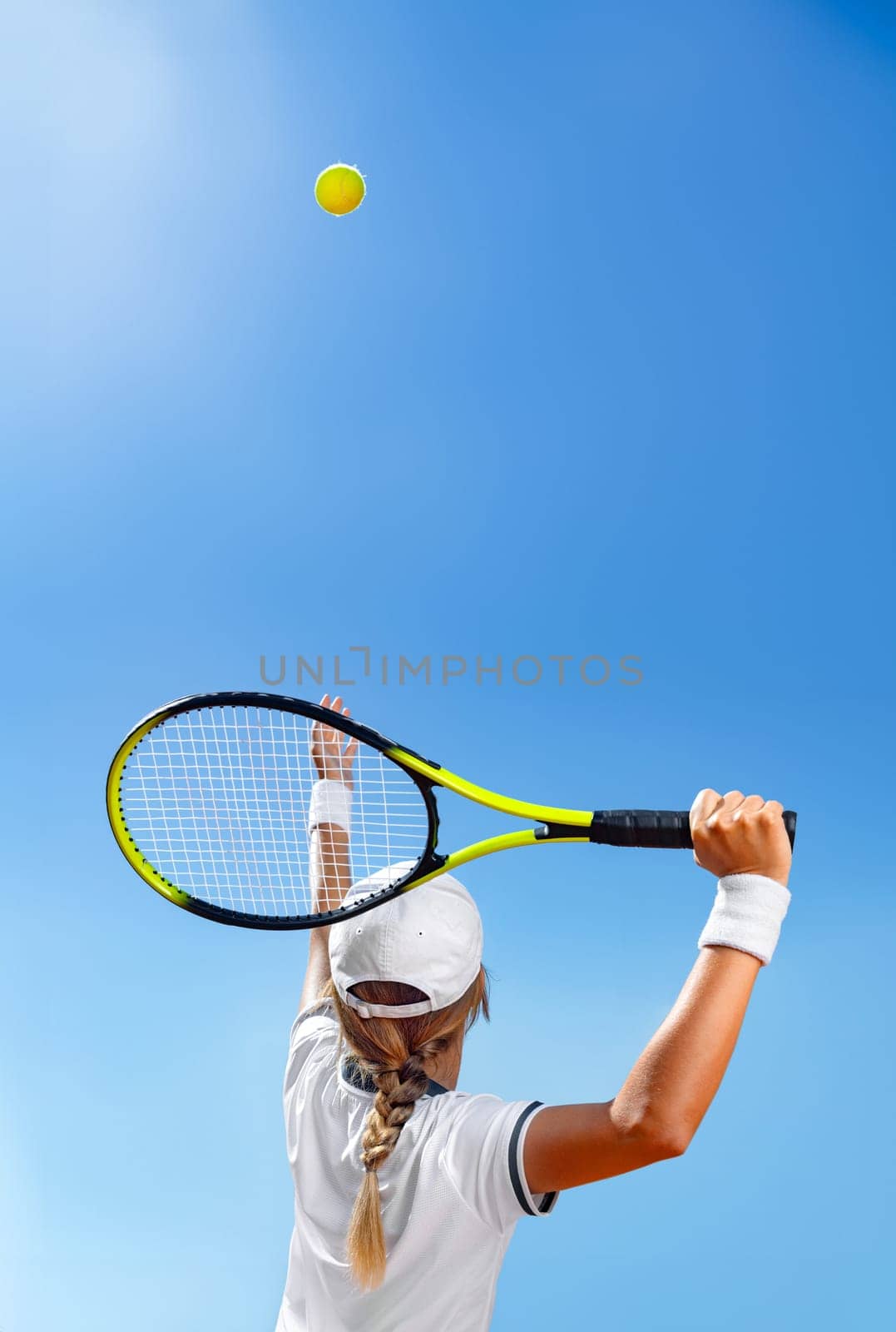 Tennis player woman with racket on the court outdoors. Download a photo of a tennis player girl to advertise sporting events in social media. Vertical photo for stories, reels or shorts. by MikeOrlov