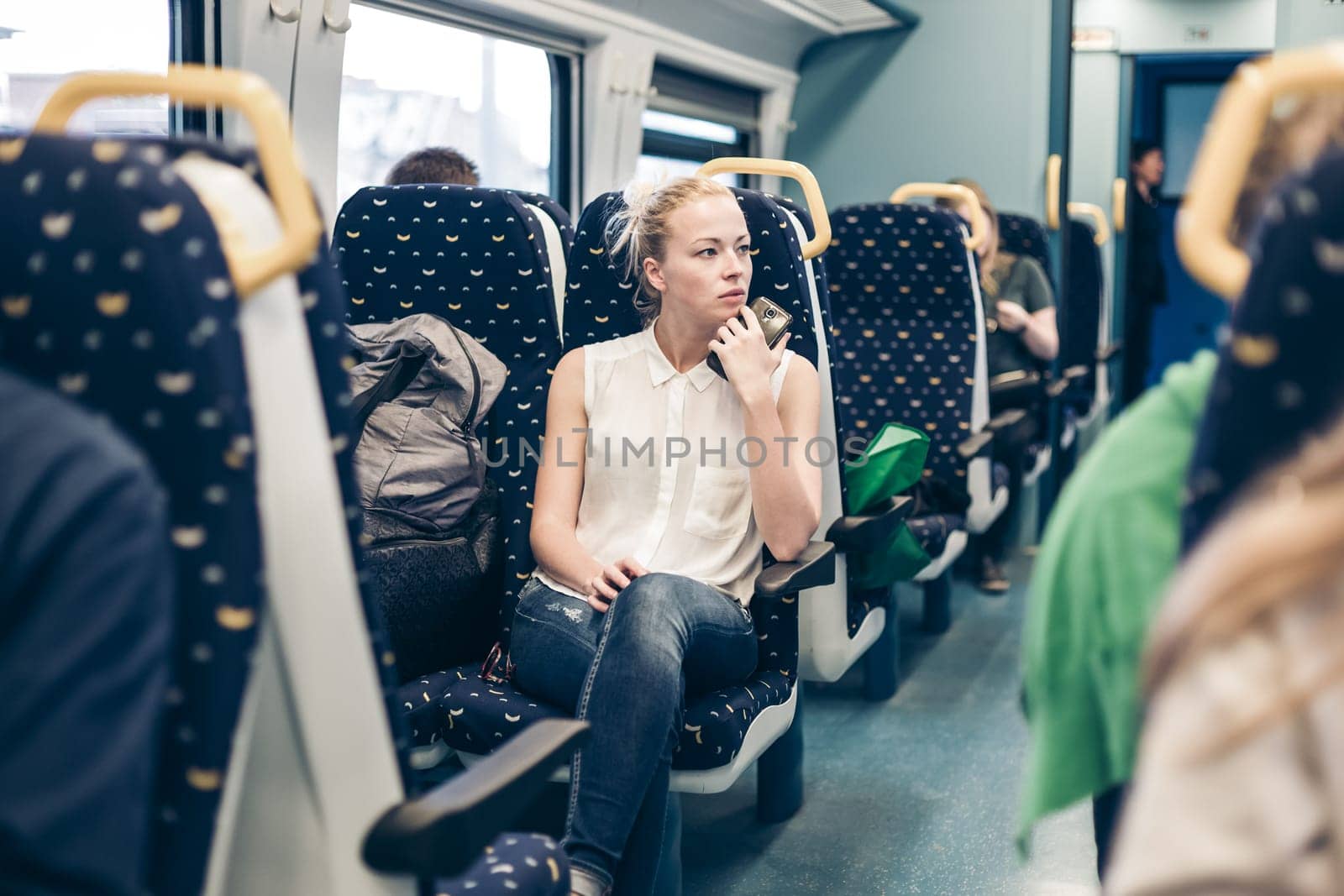 Young woman looking trough window while traveling by train.