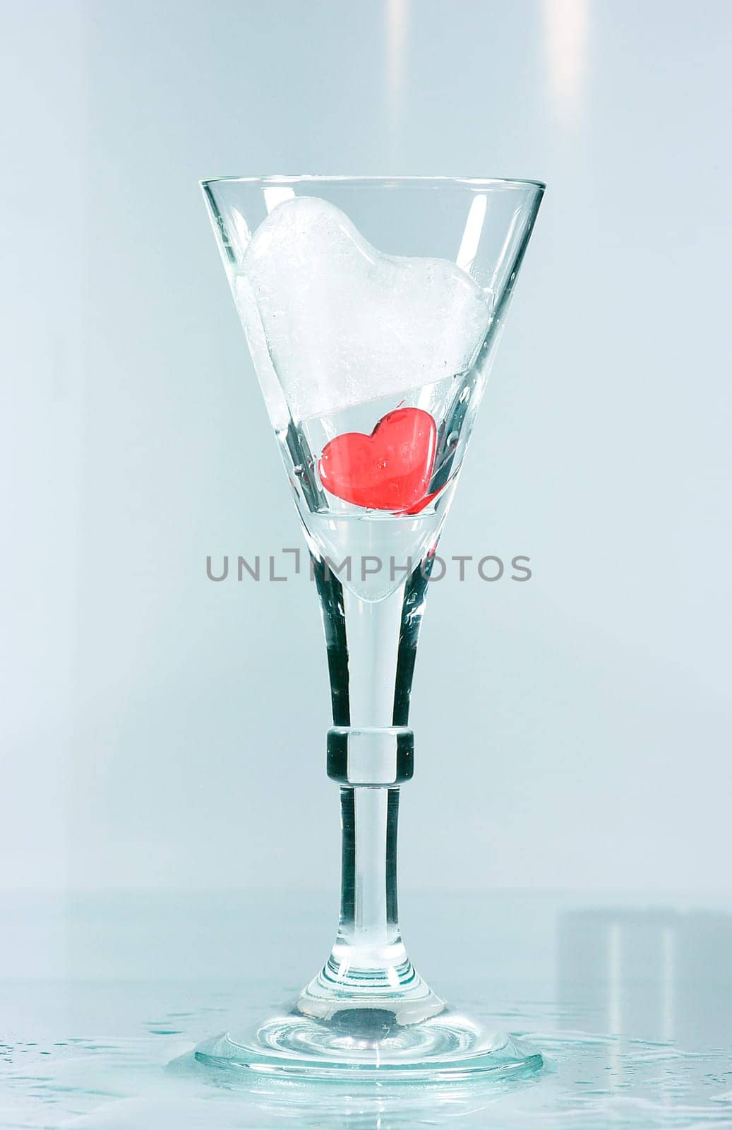 Red heart and ice heart in a glass. A Valentine's greeting.