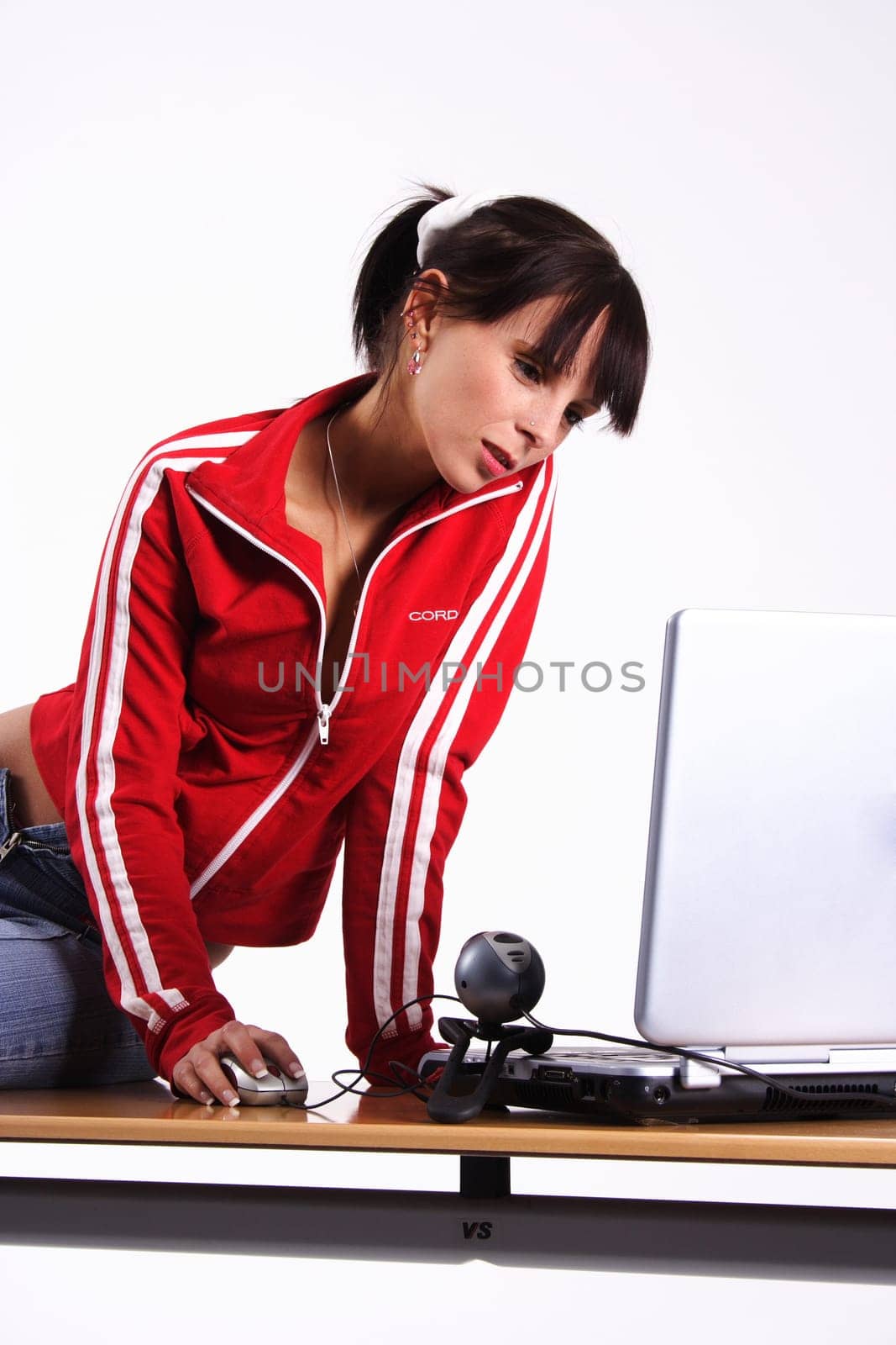 A young woman sitting in front of the laptop with webcam