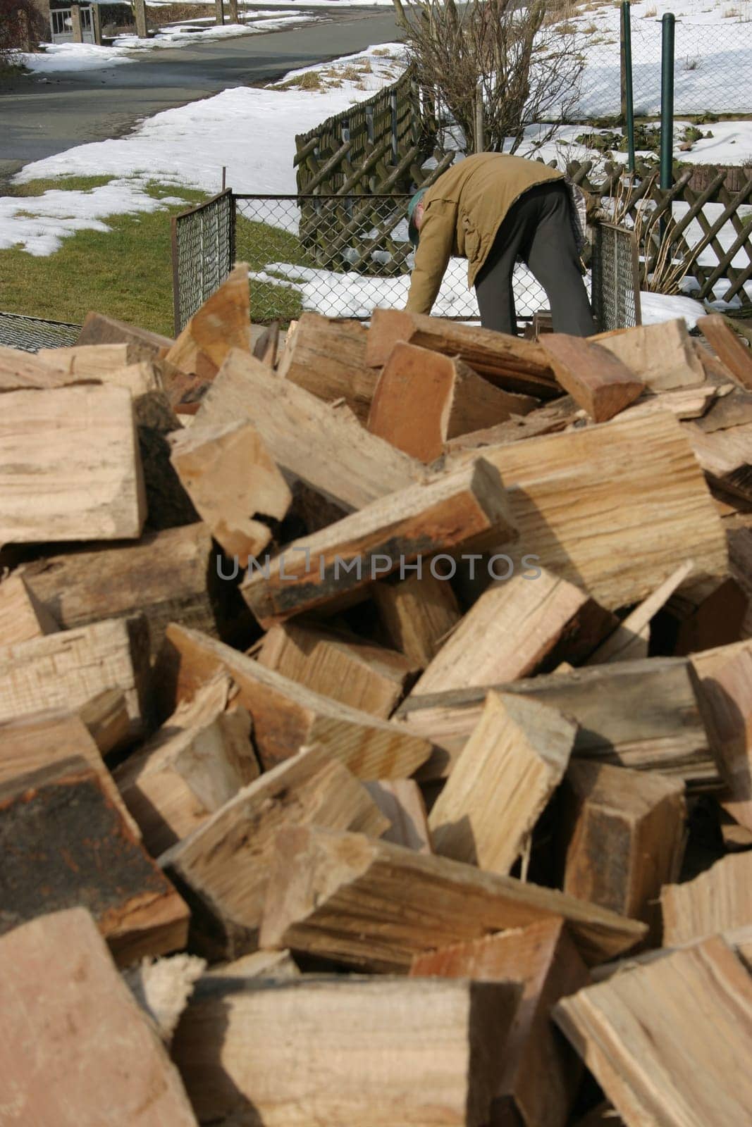 Just delivered firewood - in the background a man starts building the wooden fin for the logs