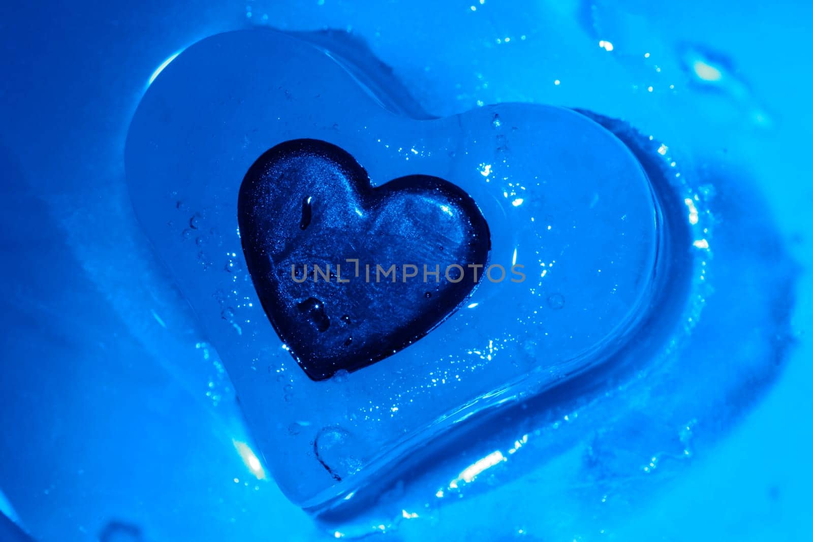 Heart frozen in the ice heart,illuminated with blue light.