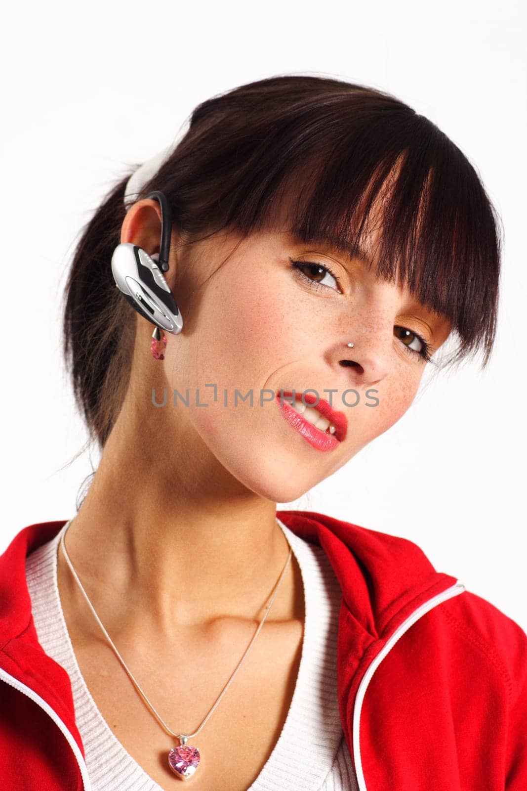 Photo shows a smiling young woman wearing a headset