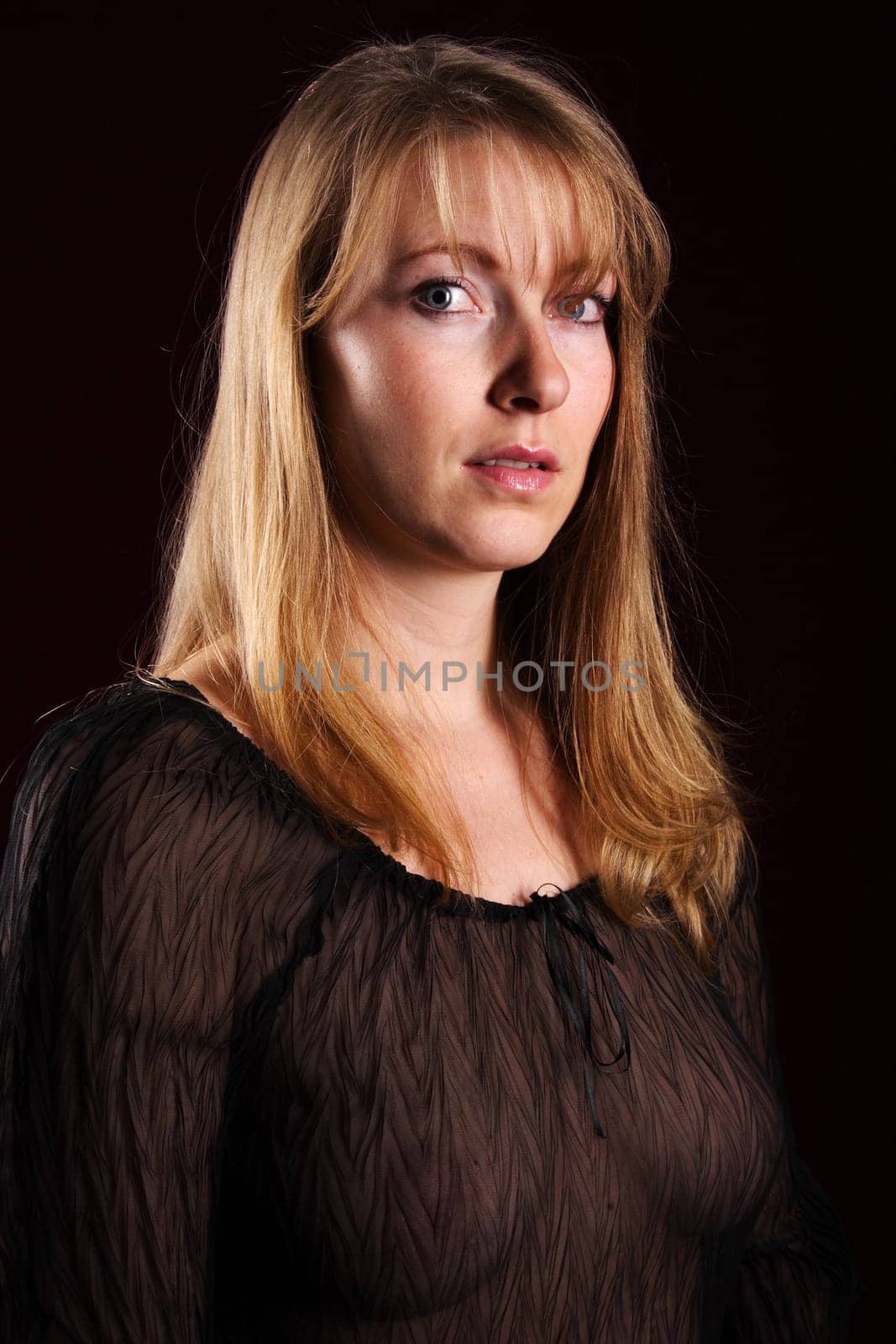 Photo shows a woman in erotic representation with a serious look.
