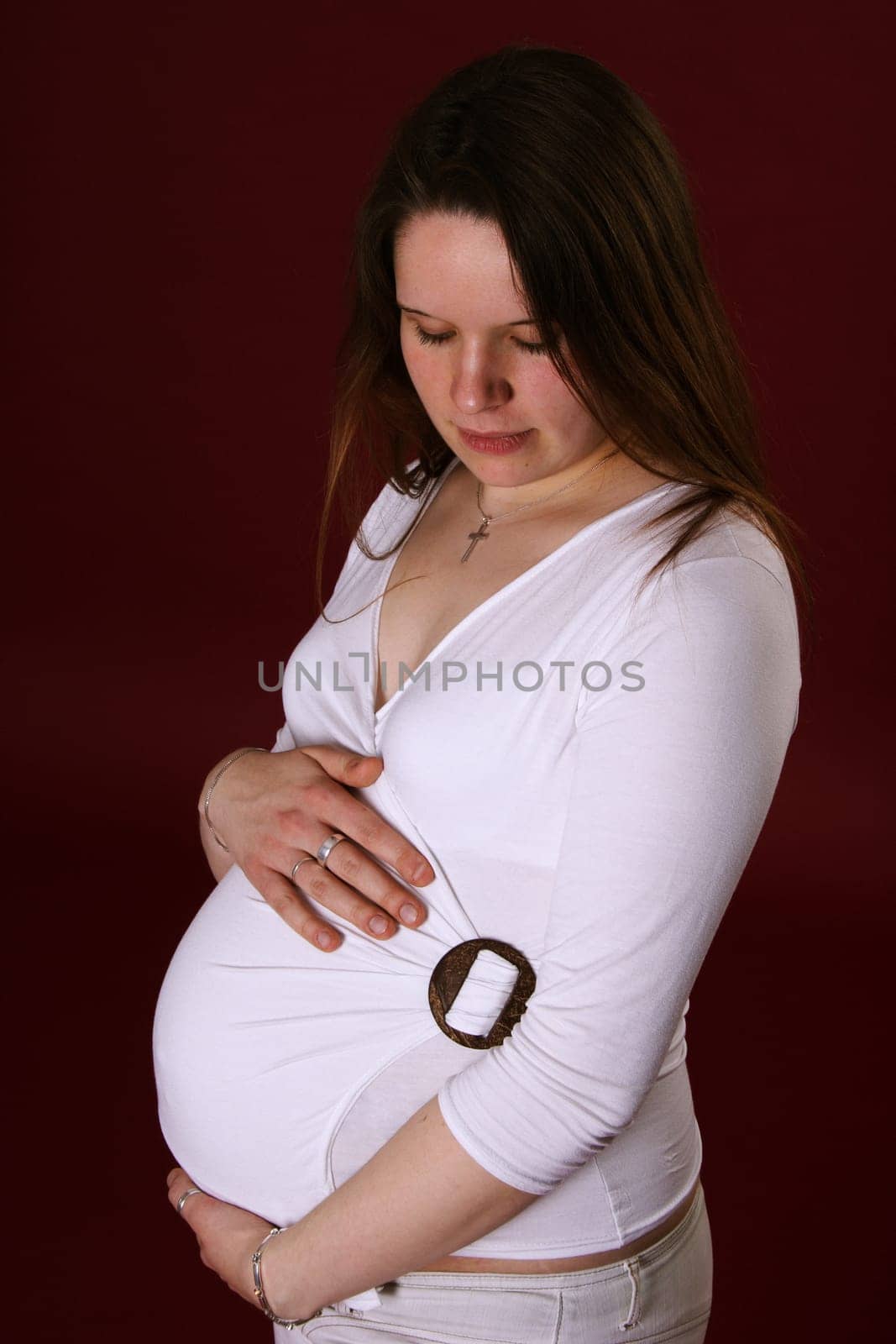 The photo shows a pregnant woman lovingly hugging the belly