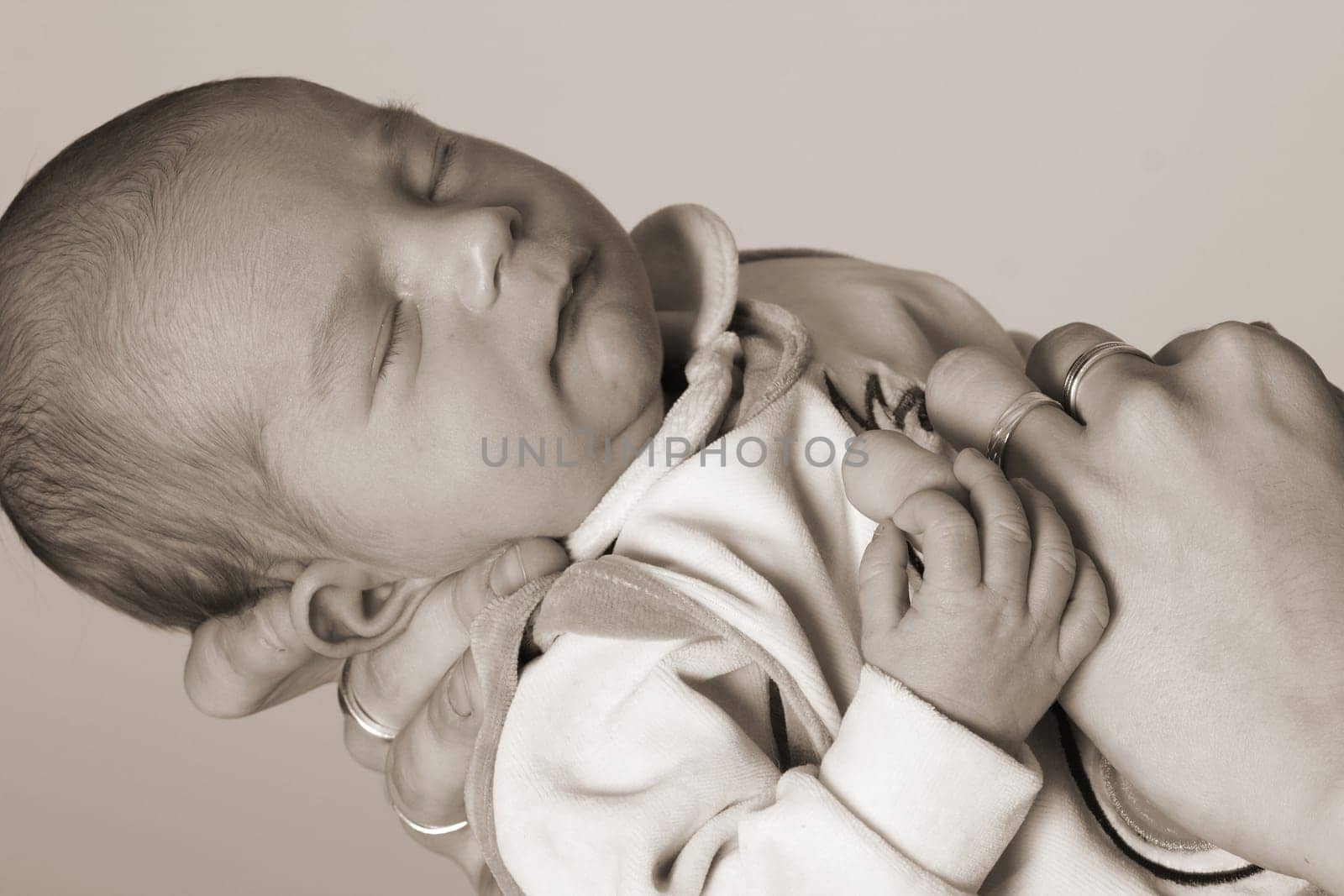Photo shows a baby lying in the mother's hand