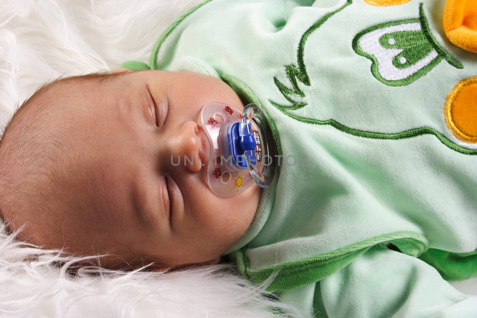 Photo shows a large baby with a pacifier