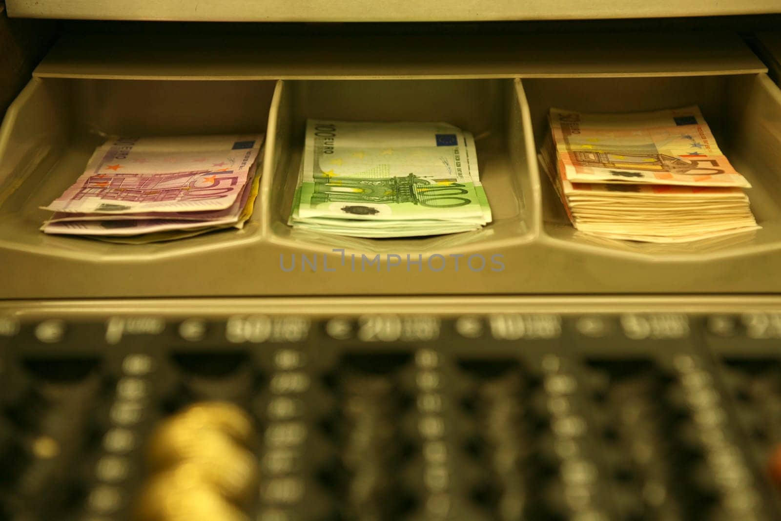 Euro banknotes in a cash register with note compartments