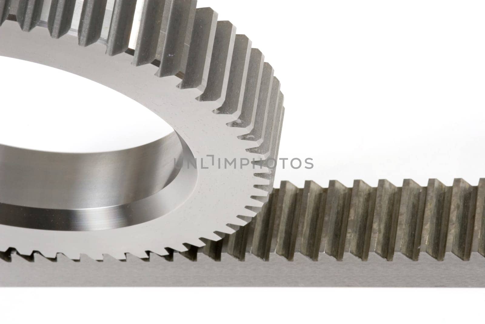 Close-up of the connection between a gear and a rack isolated on a white background