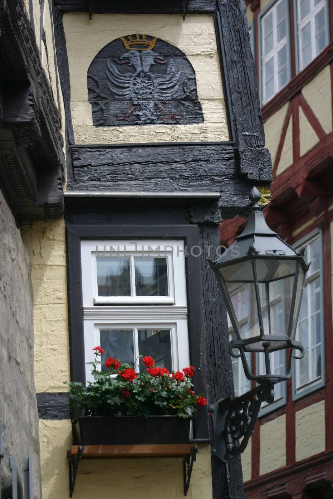 Lantern and geraniums on a half-timbered house in Quedlinburg