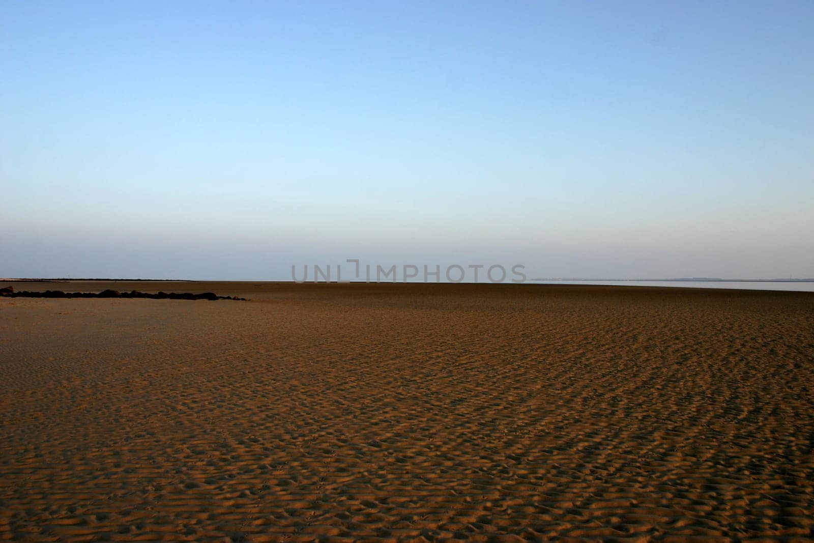 No,this is not a desert! But the North Sea beach on the island of Föhr at low tide,so that you can see the mudflats against the evening sky.