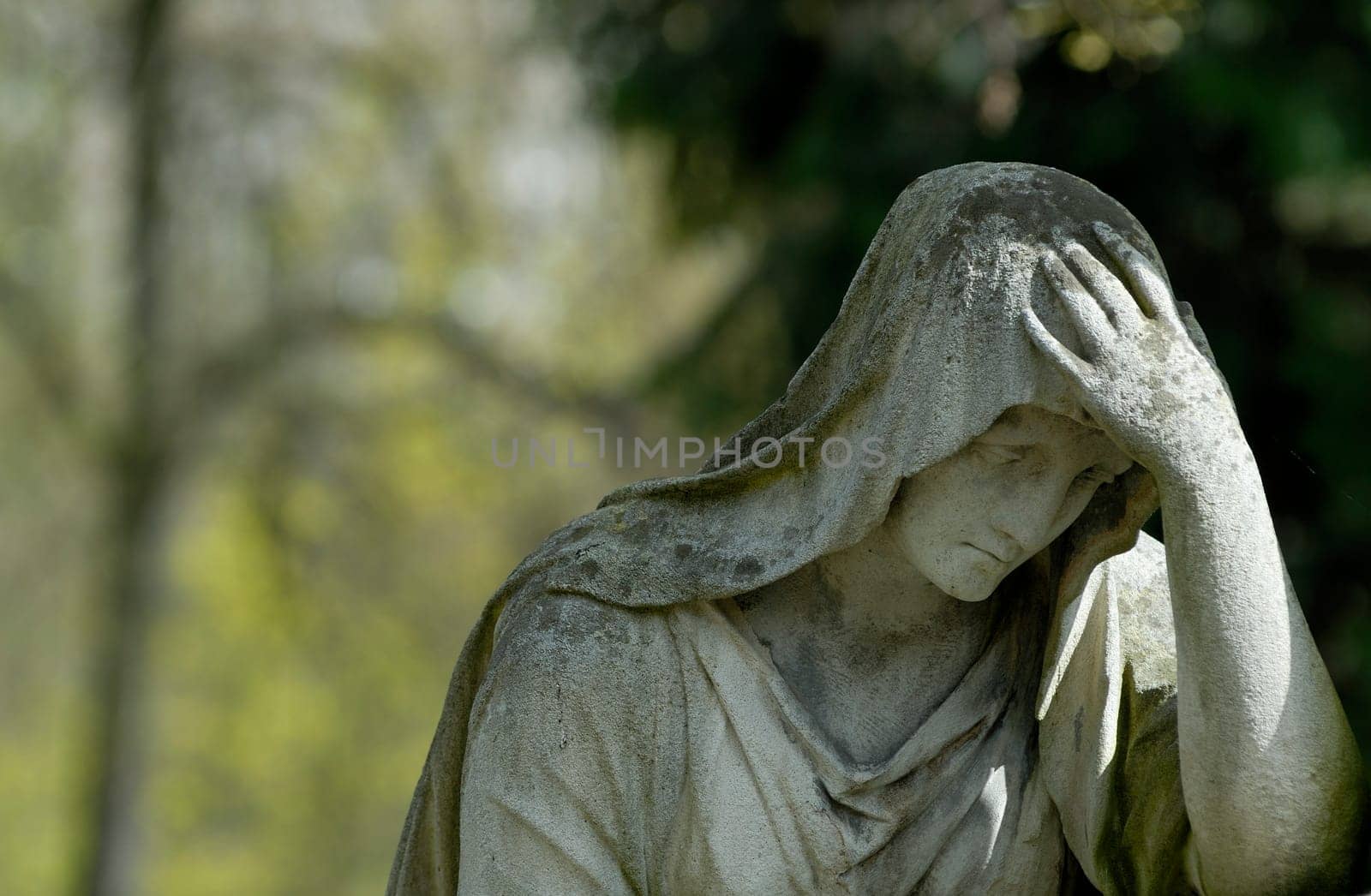 Sculpture in front of a grave.