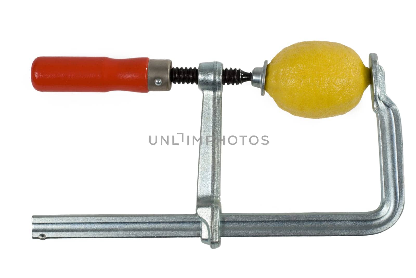 Lemon is pressed in a screw clamp