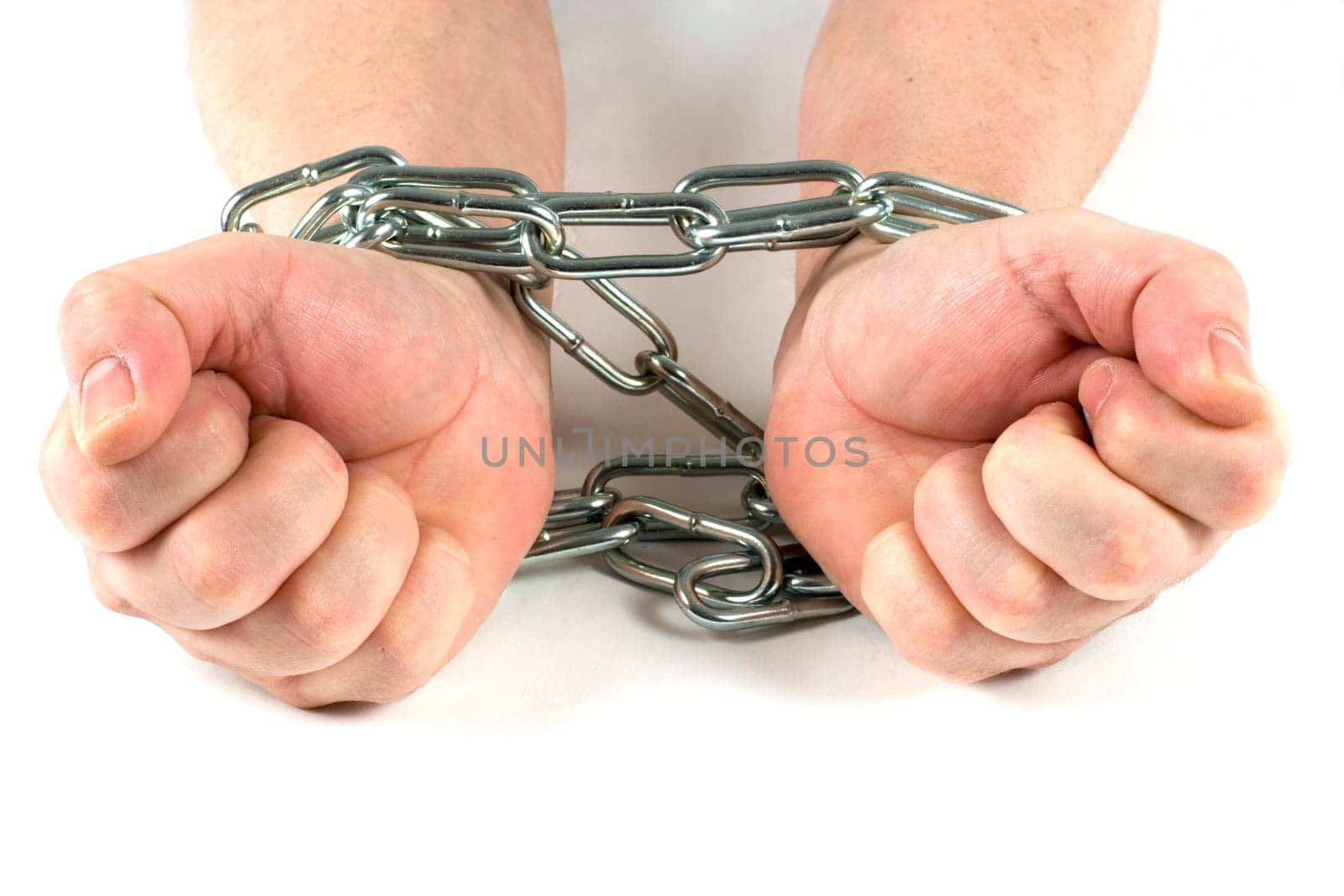 Hands tied by a chain,hands are clenched into fists