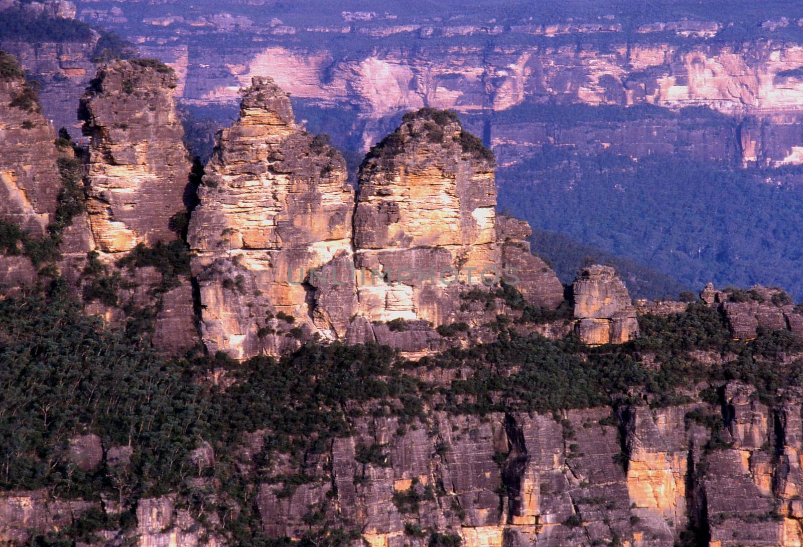 -Scan from slide- The name Blue Mountains comes from evaporating eucalyptus oil. The fine fog causes a blue glow that often lies over the mountains. So,the picture doesn't have a blue cast.