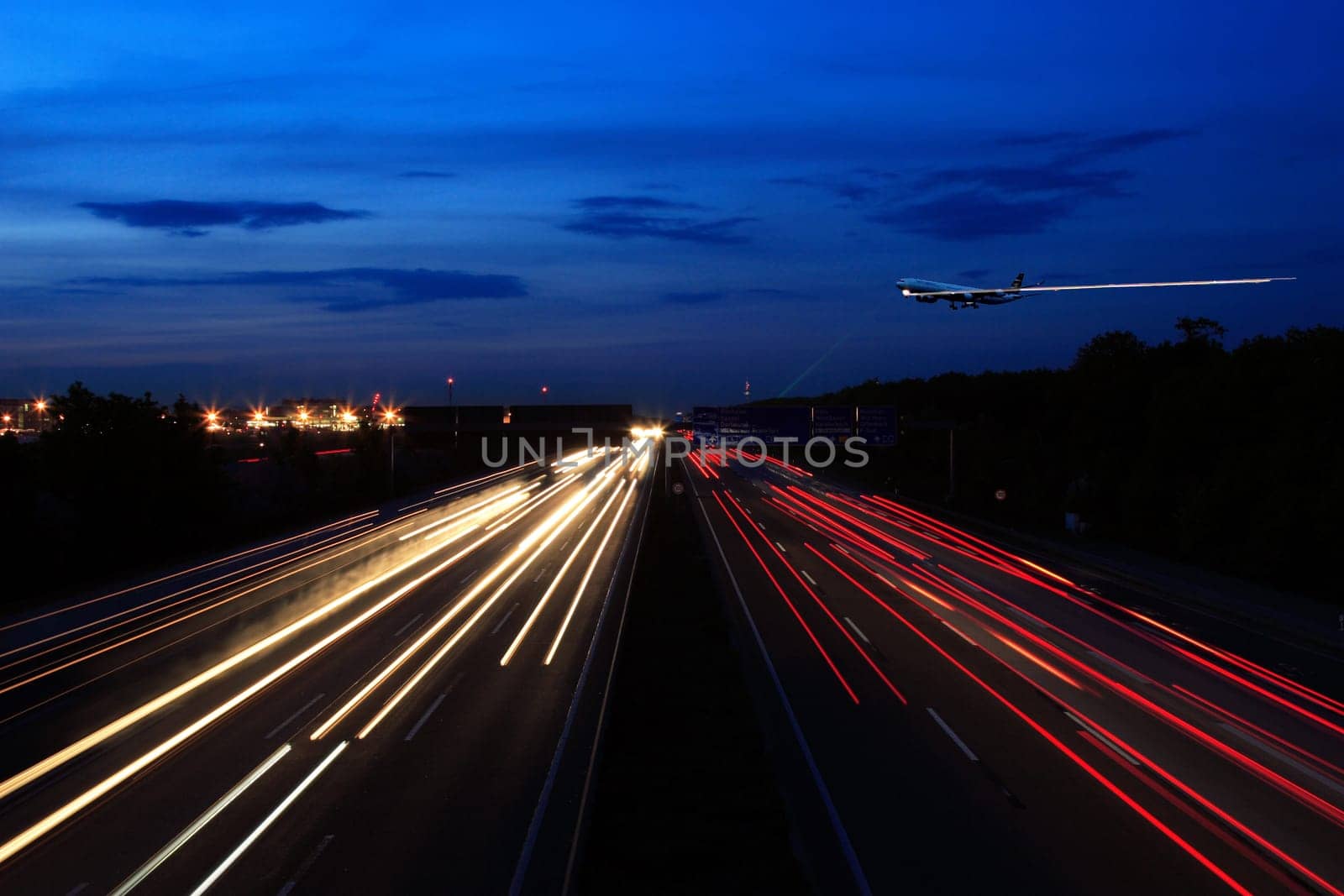 This is a montage,as you have probably seen at first glance: Airplane is at 1/60 secs. affiliated The highway is recorded at 4 secs and separately the tracer from the plane,I don't know the shutter speed anymore