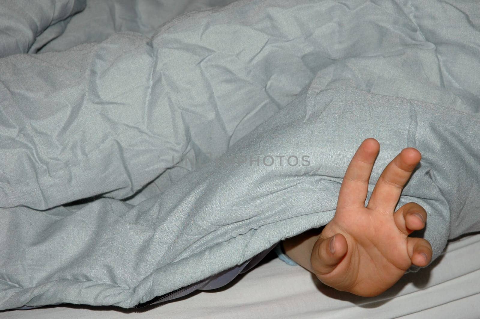 Waving hand under blanket