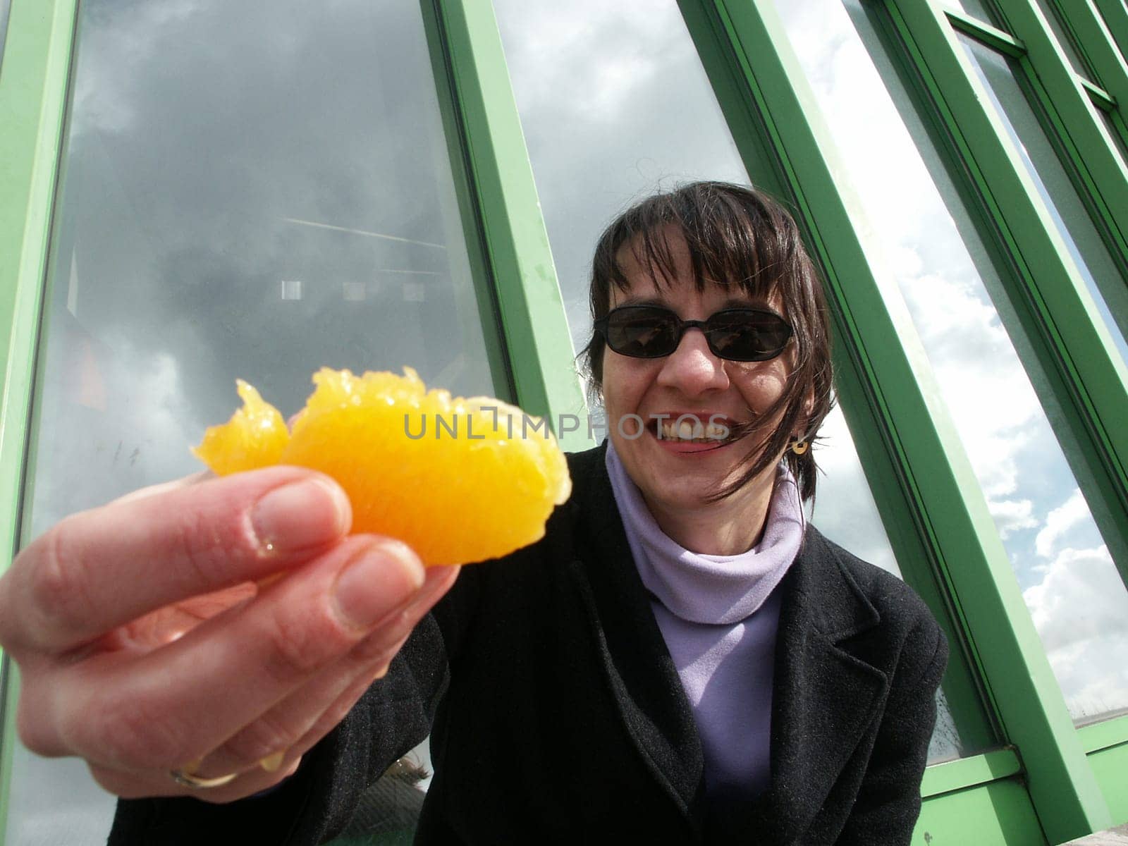 Woman offers fresh orange
