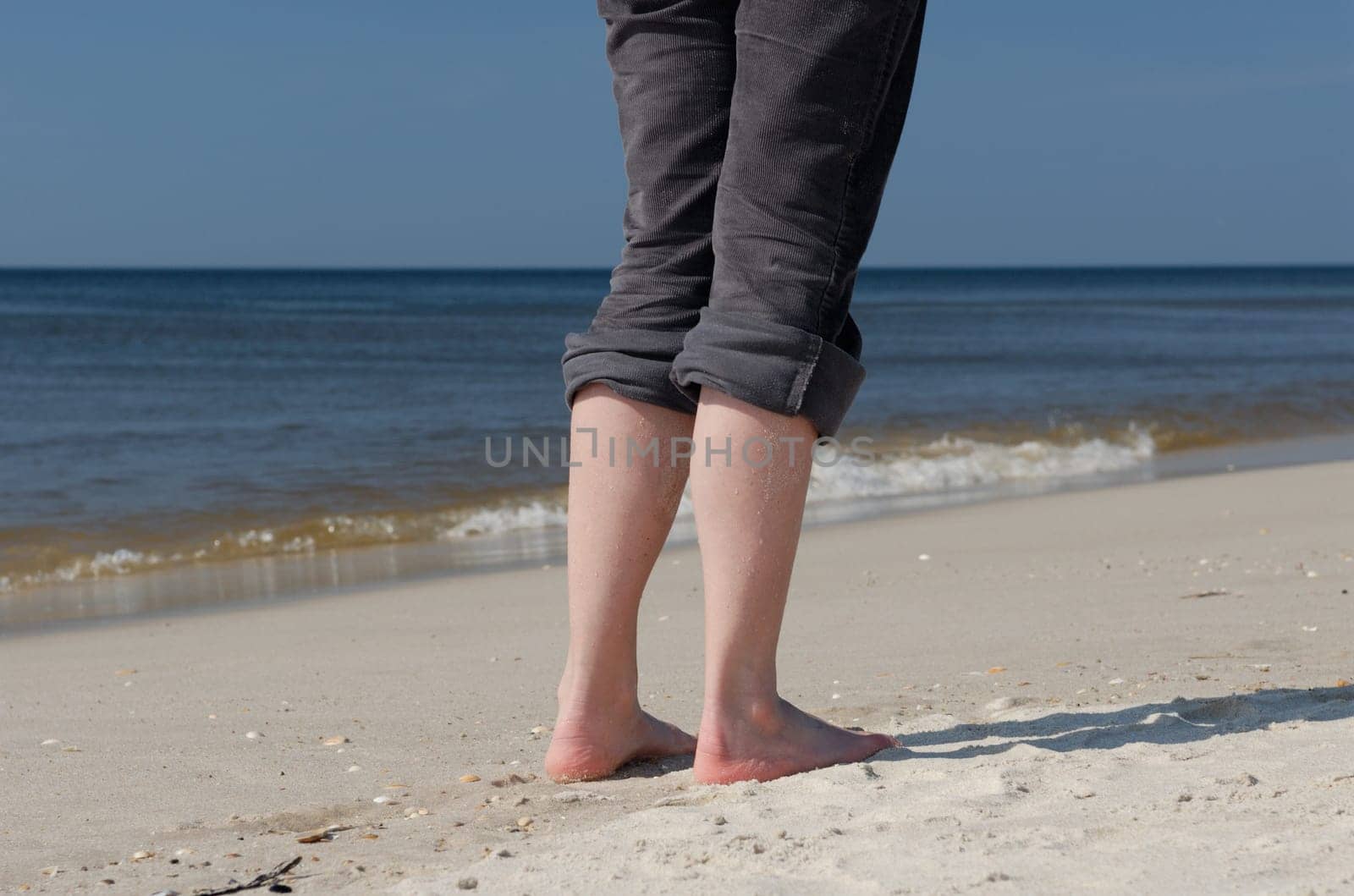 Legs of a woman on the beach