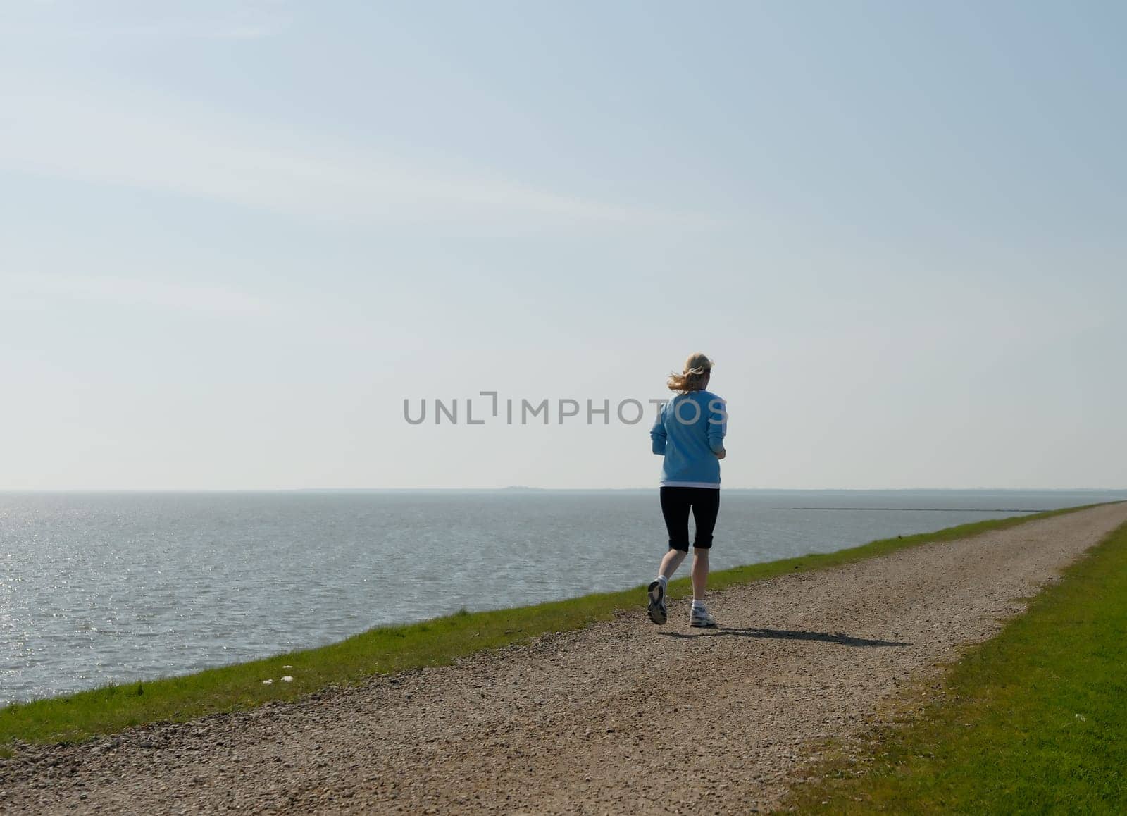 Woman jogging by the sea