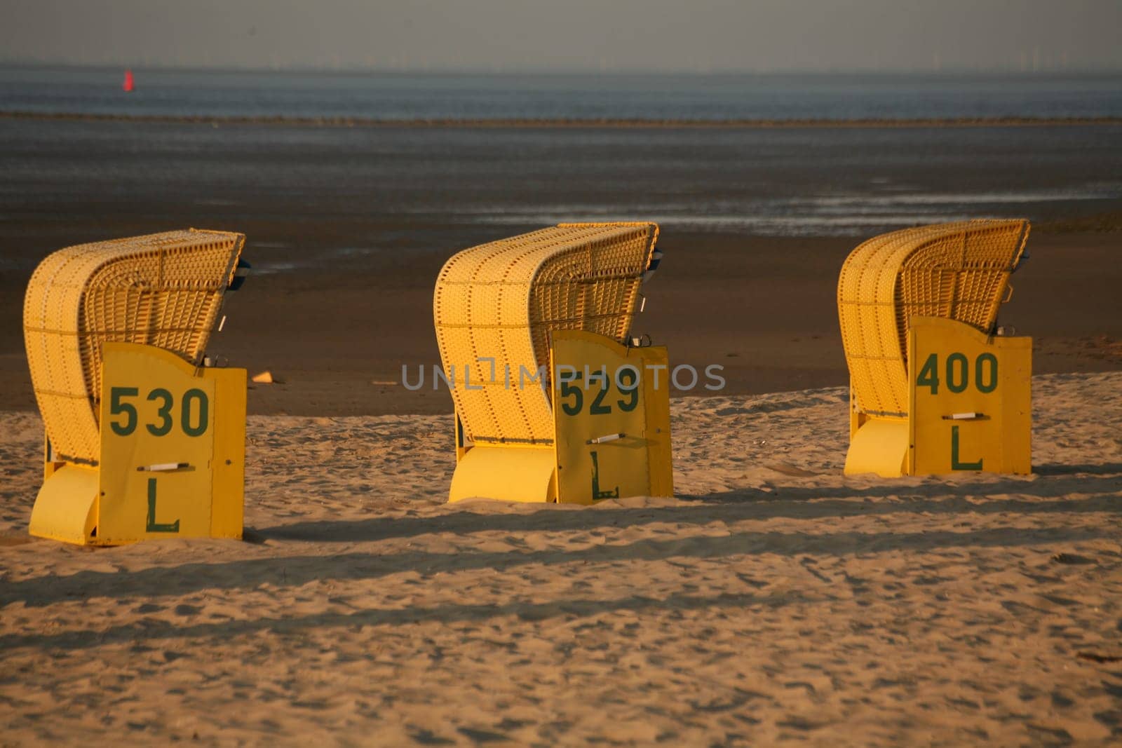 Beach chairs on the North Sea beach in the evening light