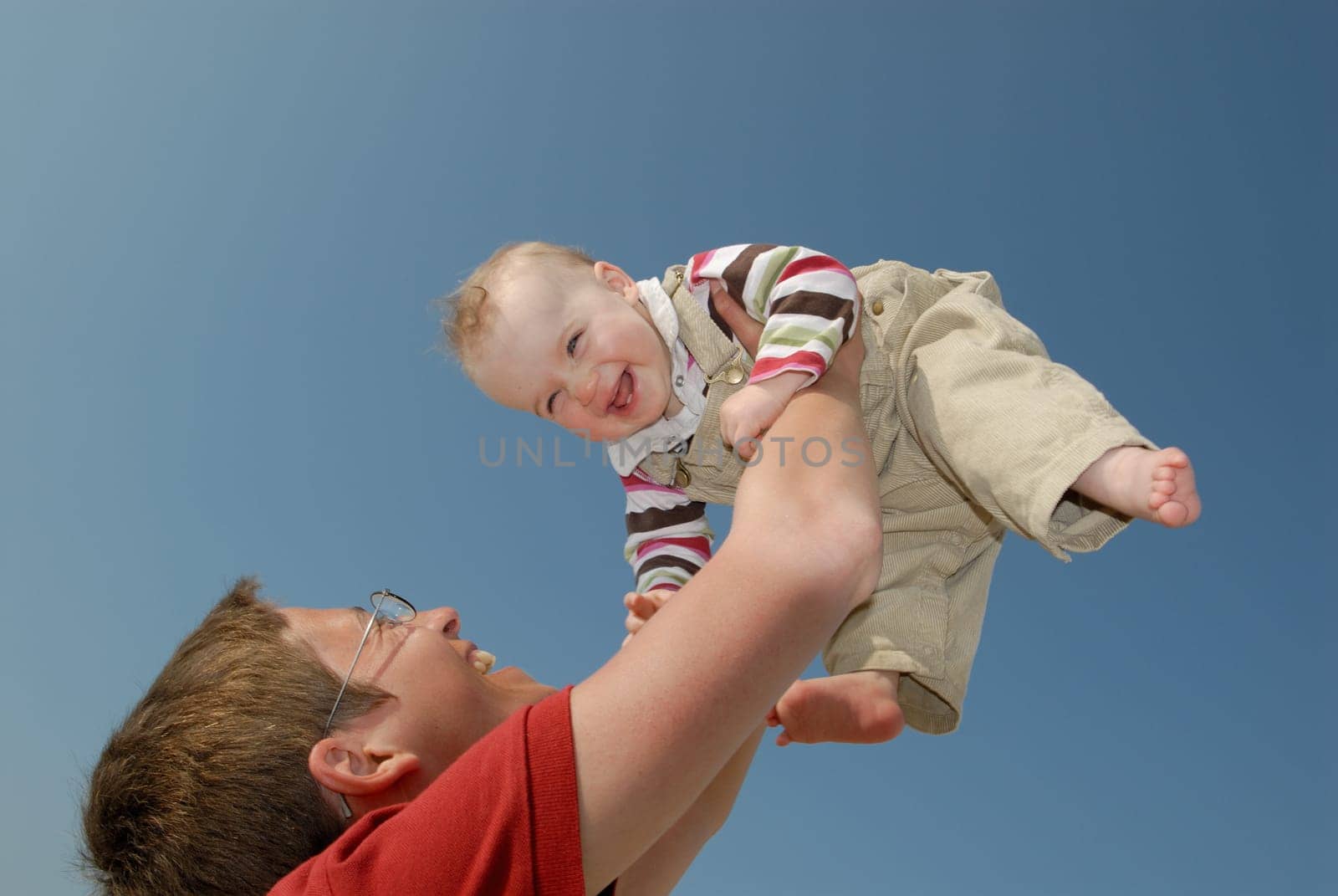 Mother and daughter in front of blue sky