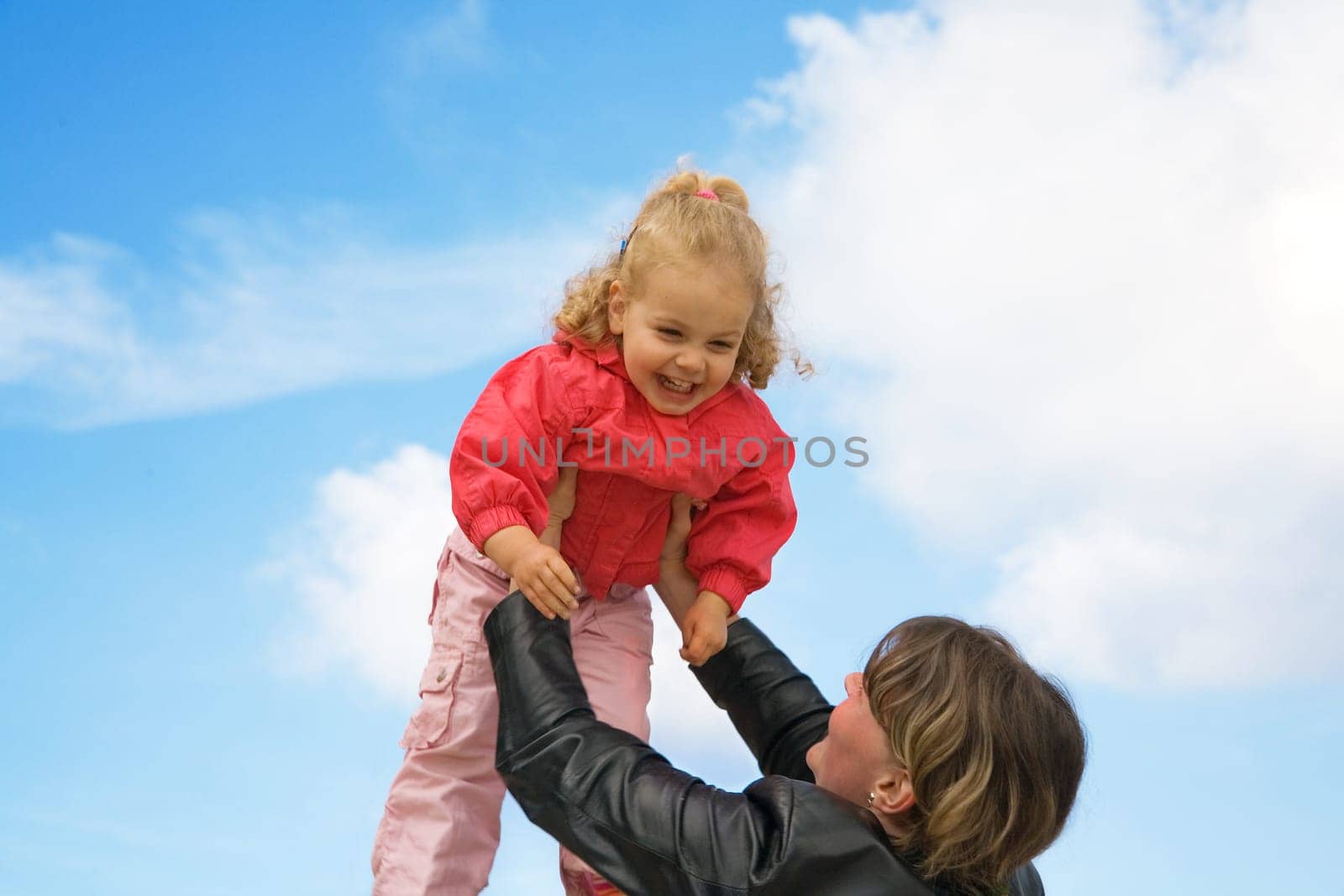 Mother and daughter playing The child is lifted up