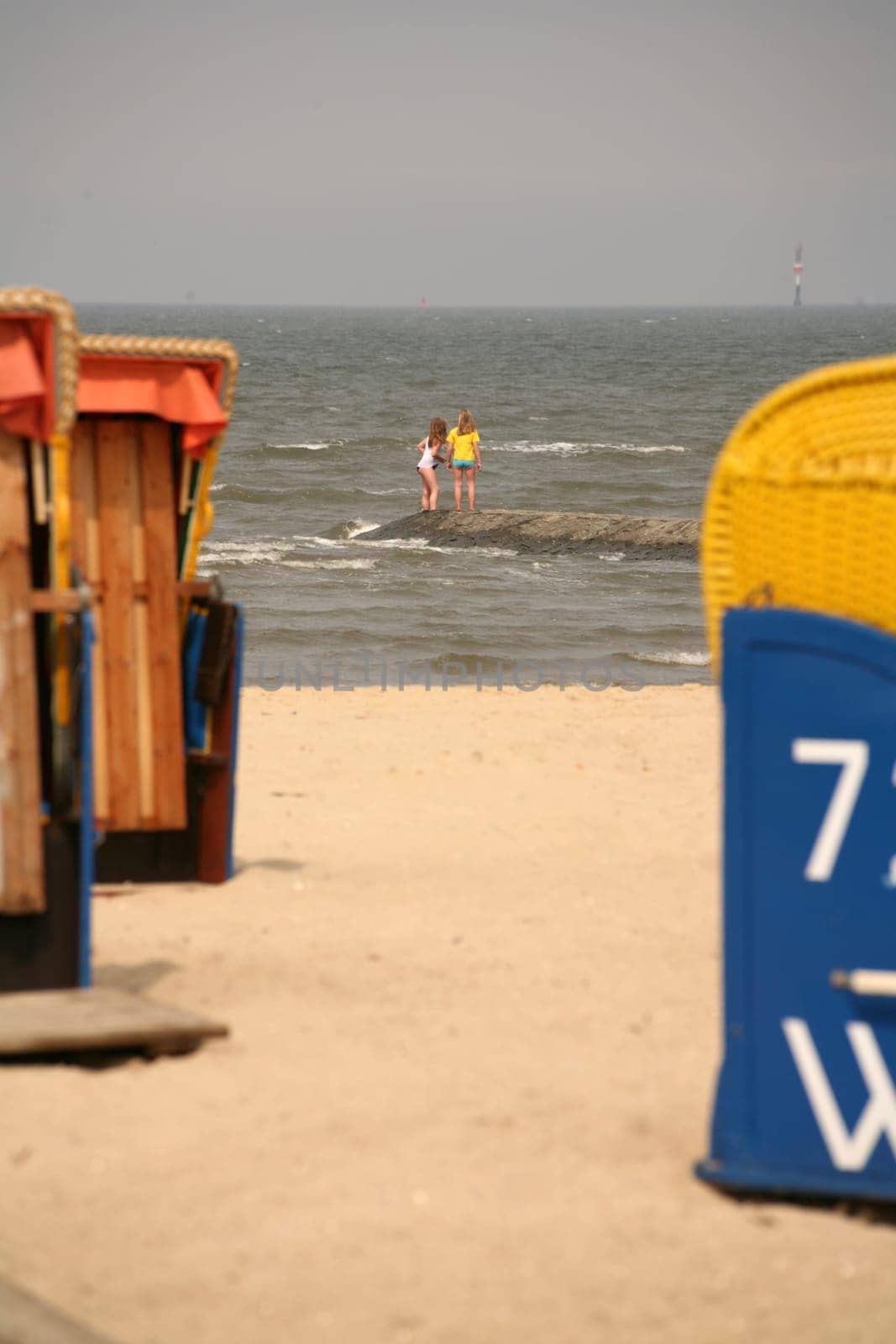 Two girls on a dune in the North Sea off Cuxhaven