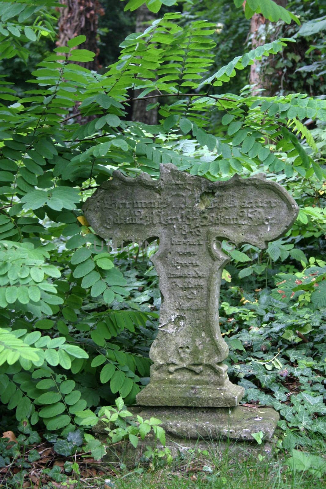 Dilapidated grave cross in an old cemetery