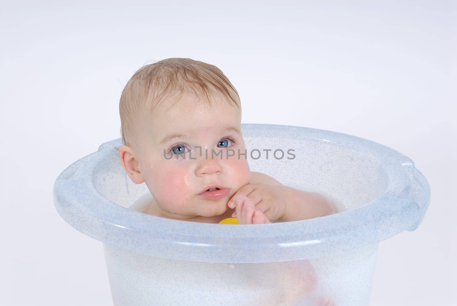 One-year-old child takes a bath (with milk)
