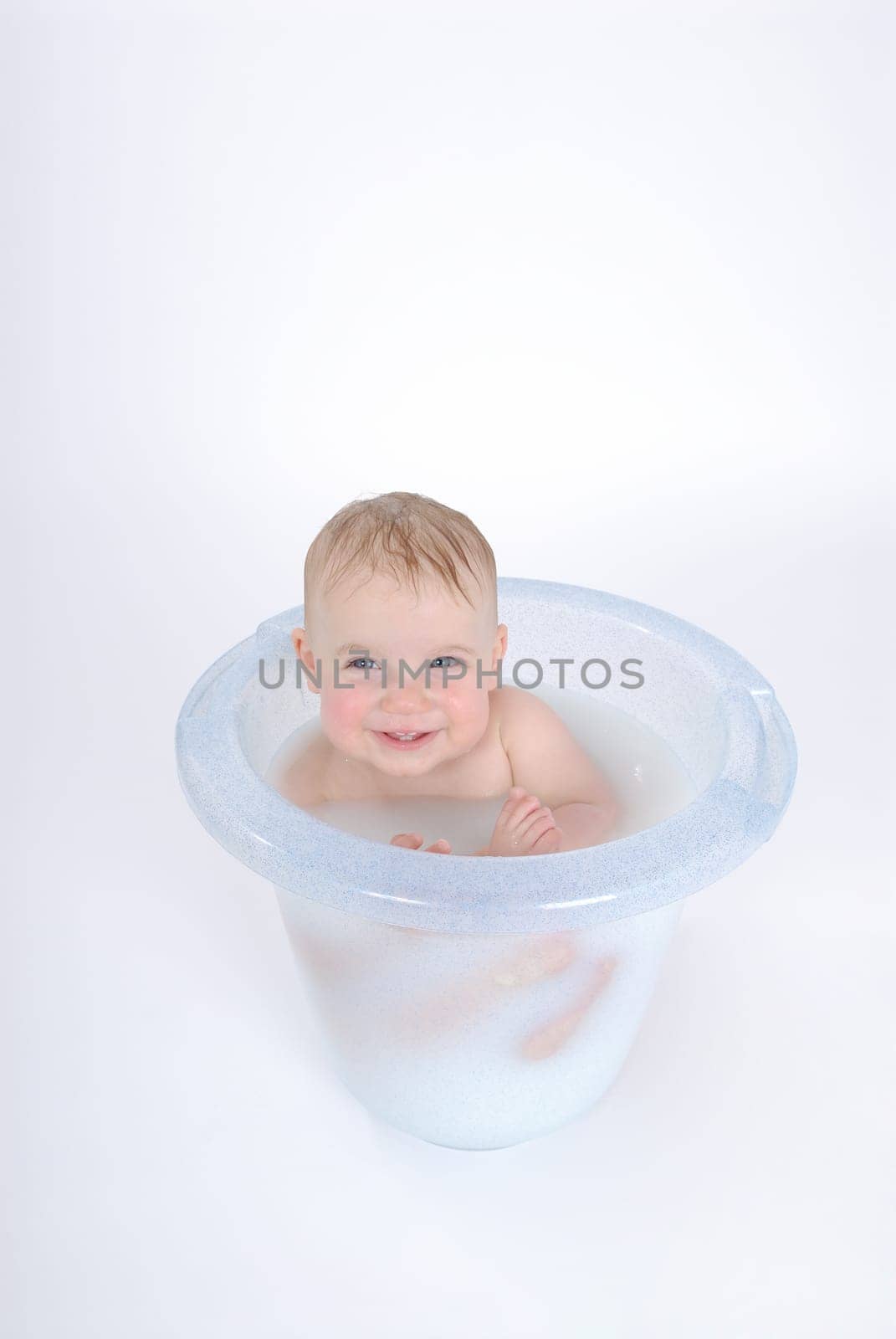 One-year-old child takes a bath (with milk)