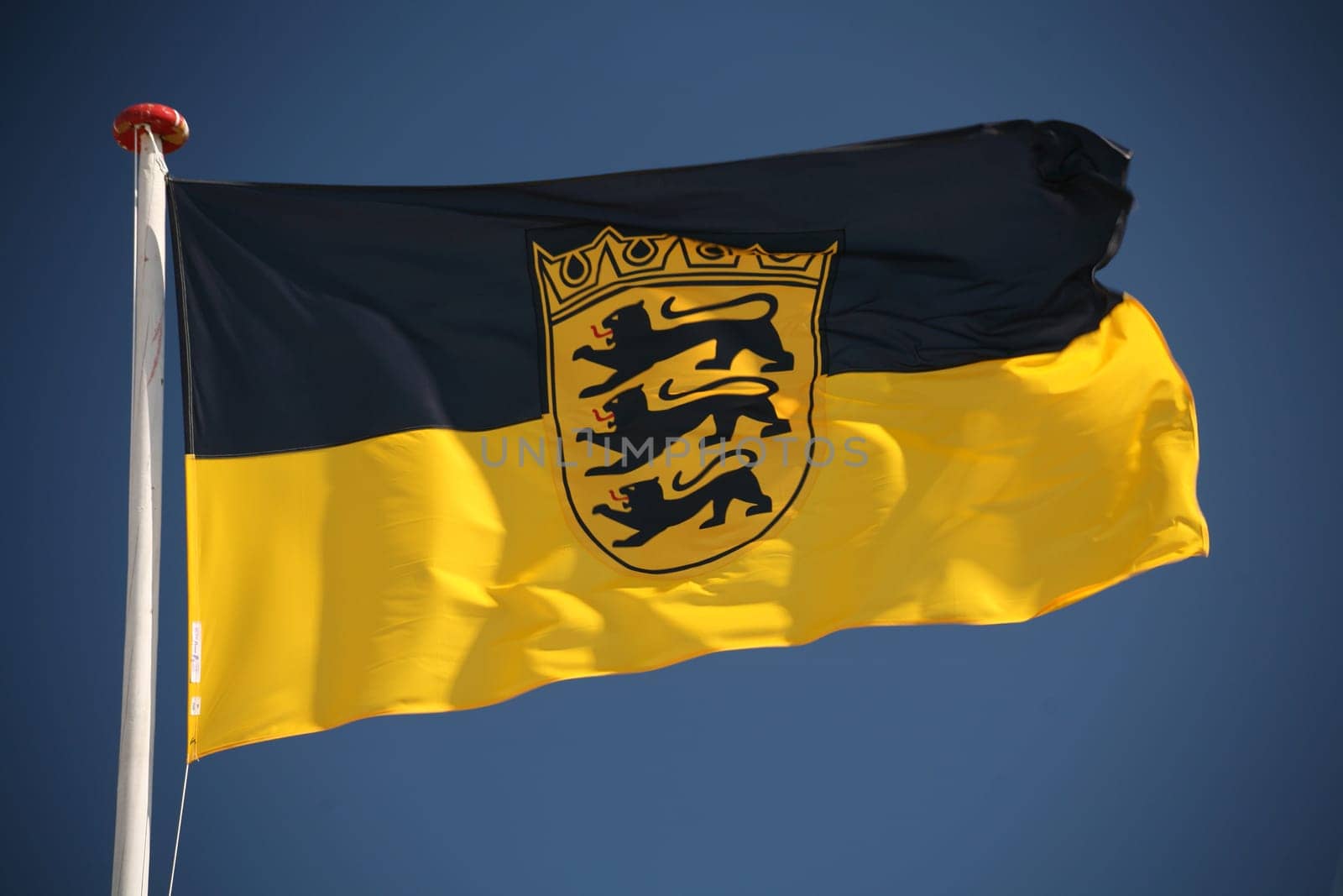 State flag of Baden-Württemberg in front of a blue sky
