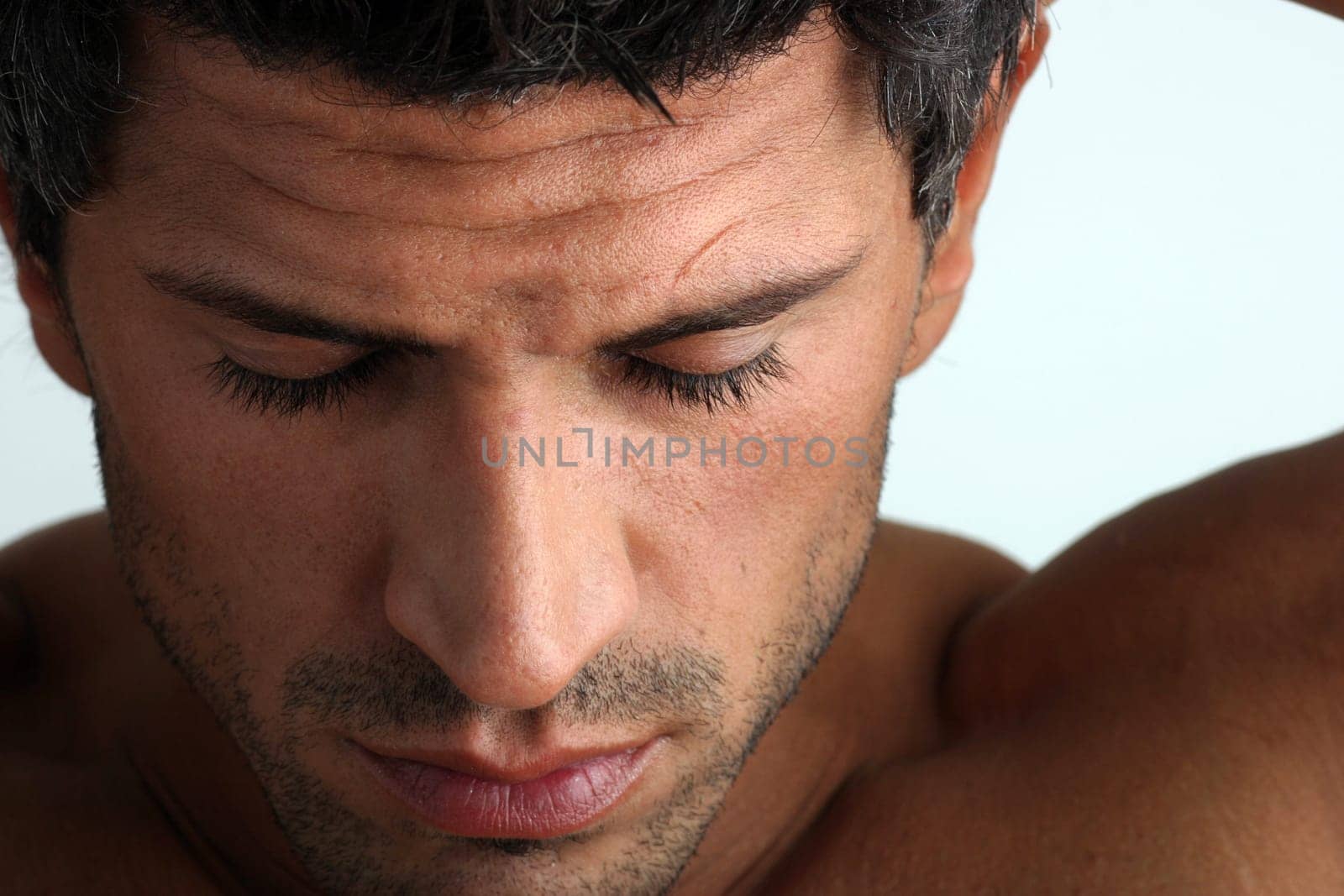 Man eyes closed looking down