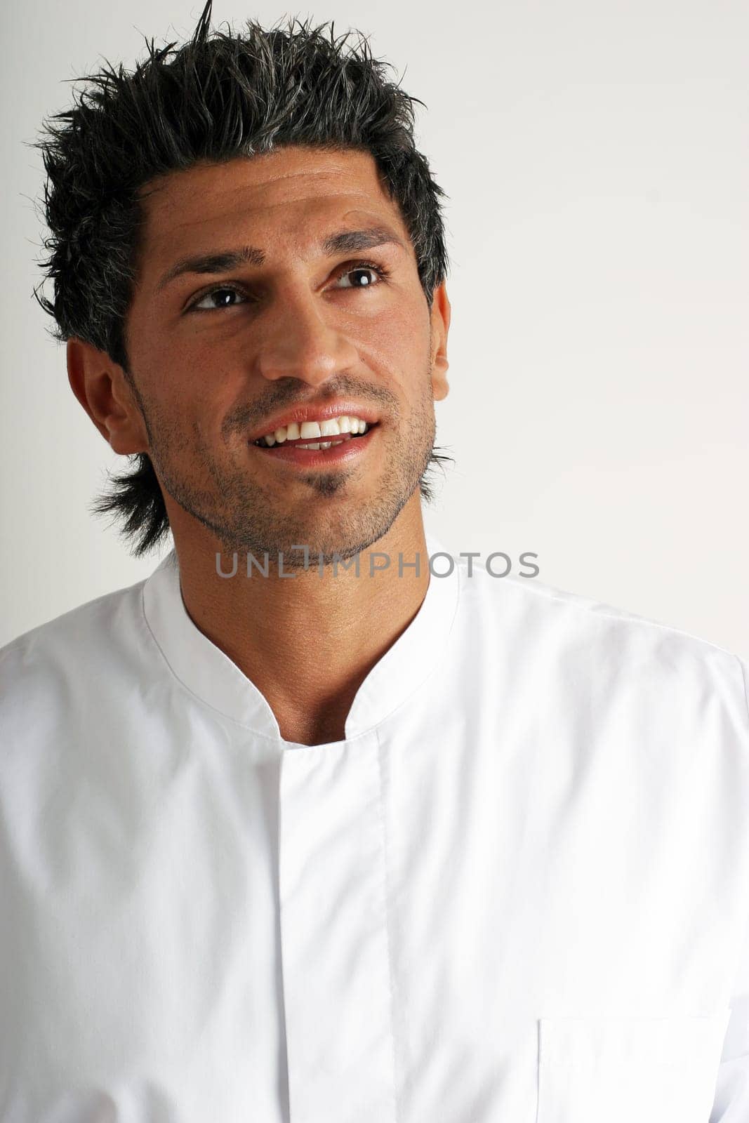 Man in white coat looking up