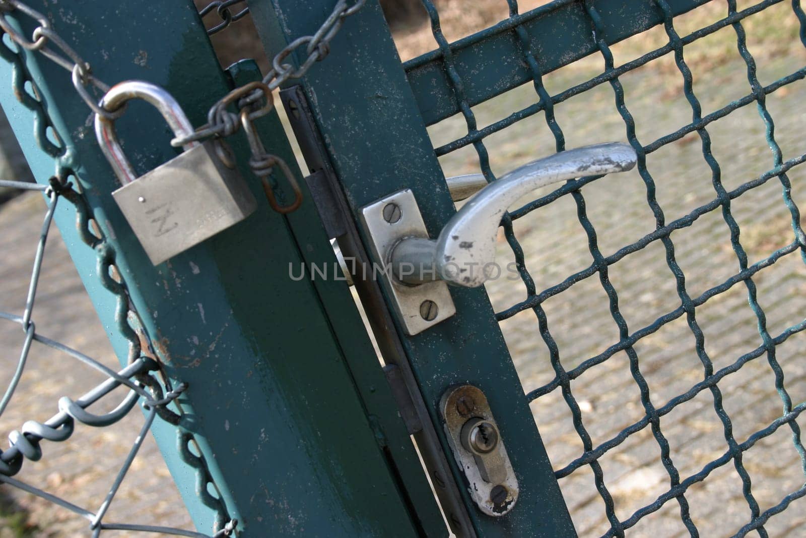 Lattice door barred with chain and lock