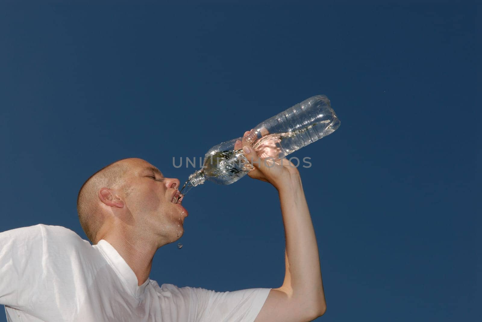 Young man drinking from a bottle of water
