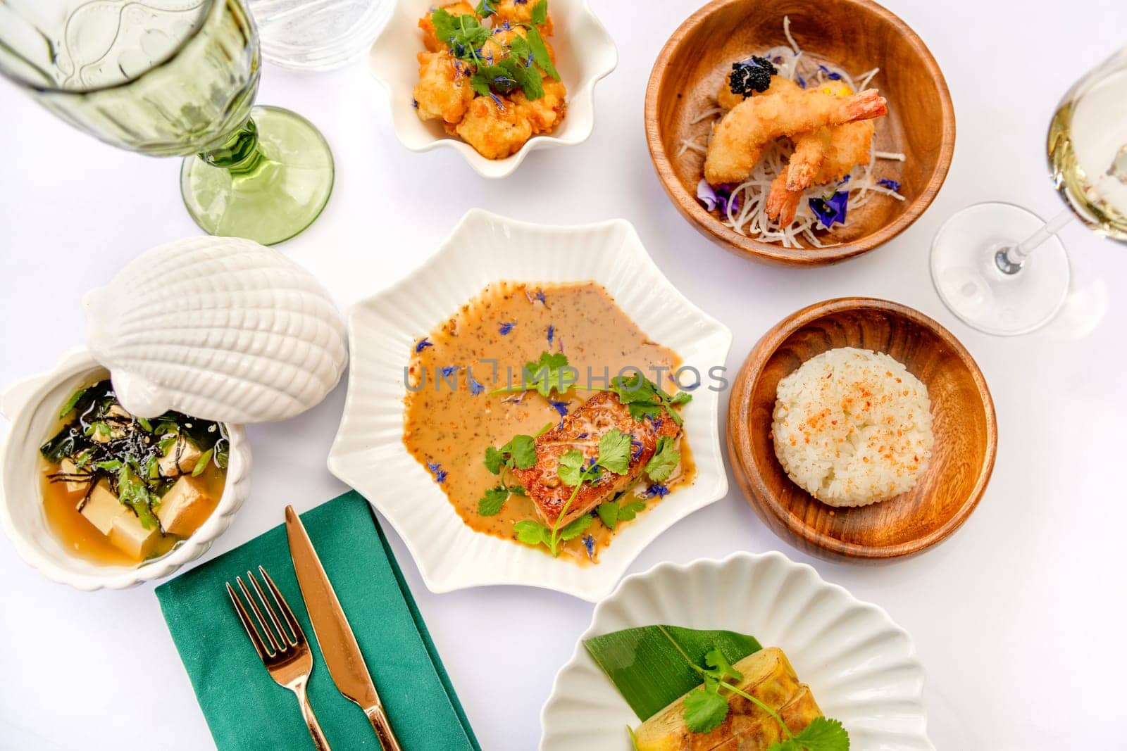 Set of Japanese dishes: miso soup, tamago, tempura shrimp, rice isolated