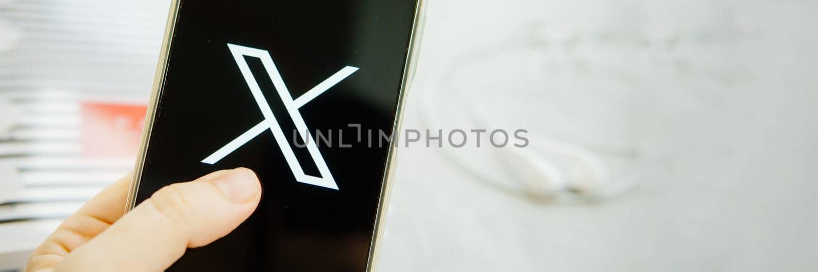 July 25, 2023, Russia. The logo in the form of the letter X displayed on the smartphone. Twitter rebranding, and implementation of X. by Annu1tochka