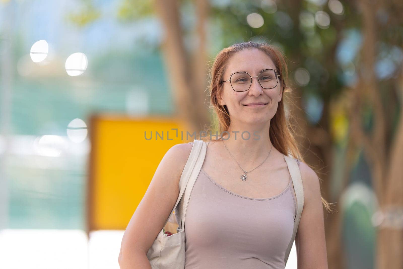Smiling ginger adult woman walking in the park