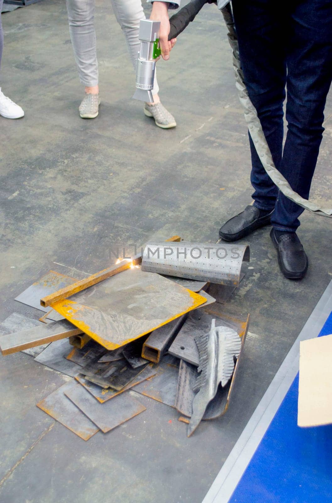 Laser metal cleaning. A man using laser metal cleaning machine to clean a metal surface from rust. Worker cleaning metal from coating by laser. Steel laser clean technologies. New modern technology