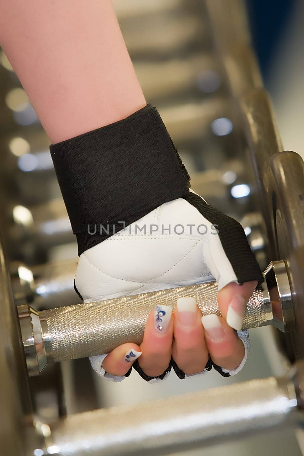 Hand gripping dumbbell